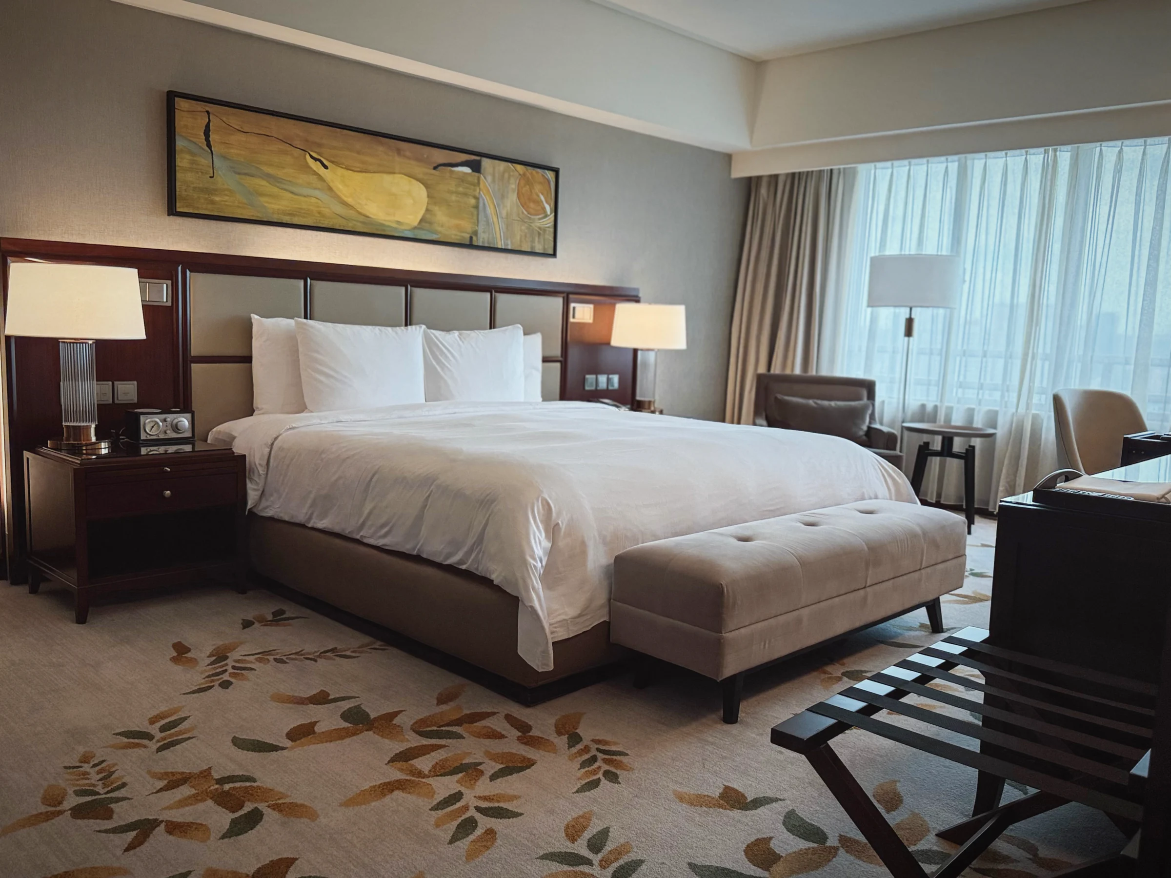 The king bed and a chair by the window