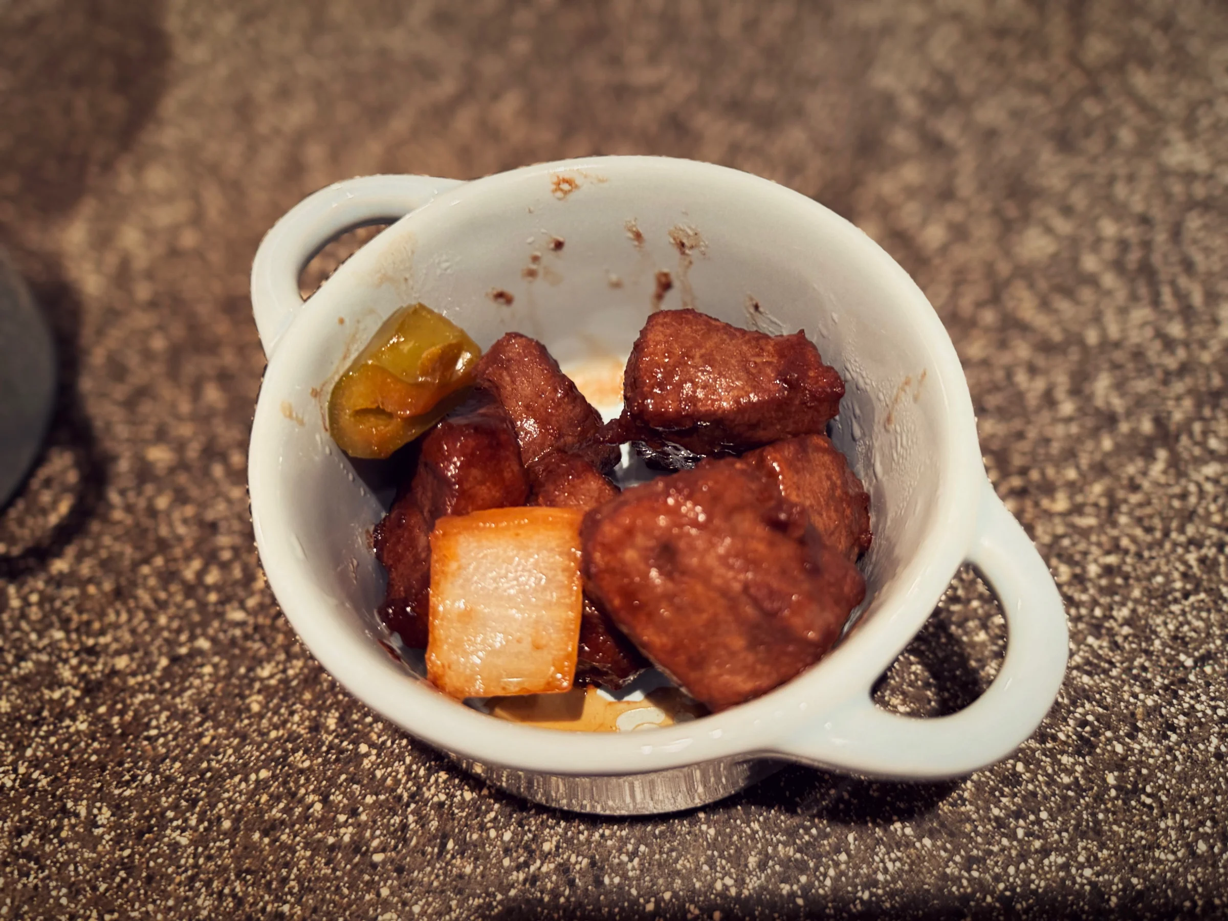 A meat dish served in a small pot