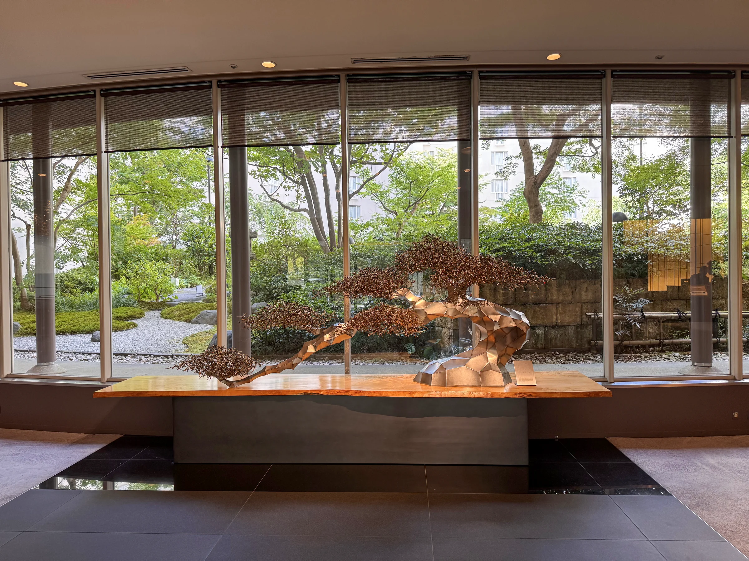Greenery beyond the windows and a display in the lobby.