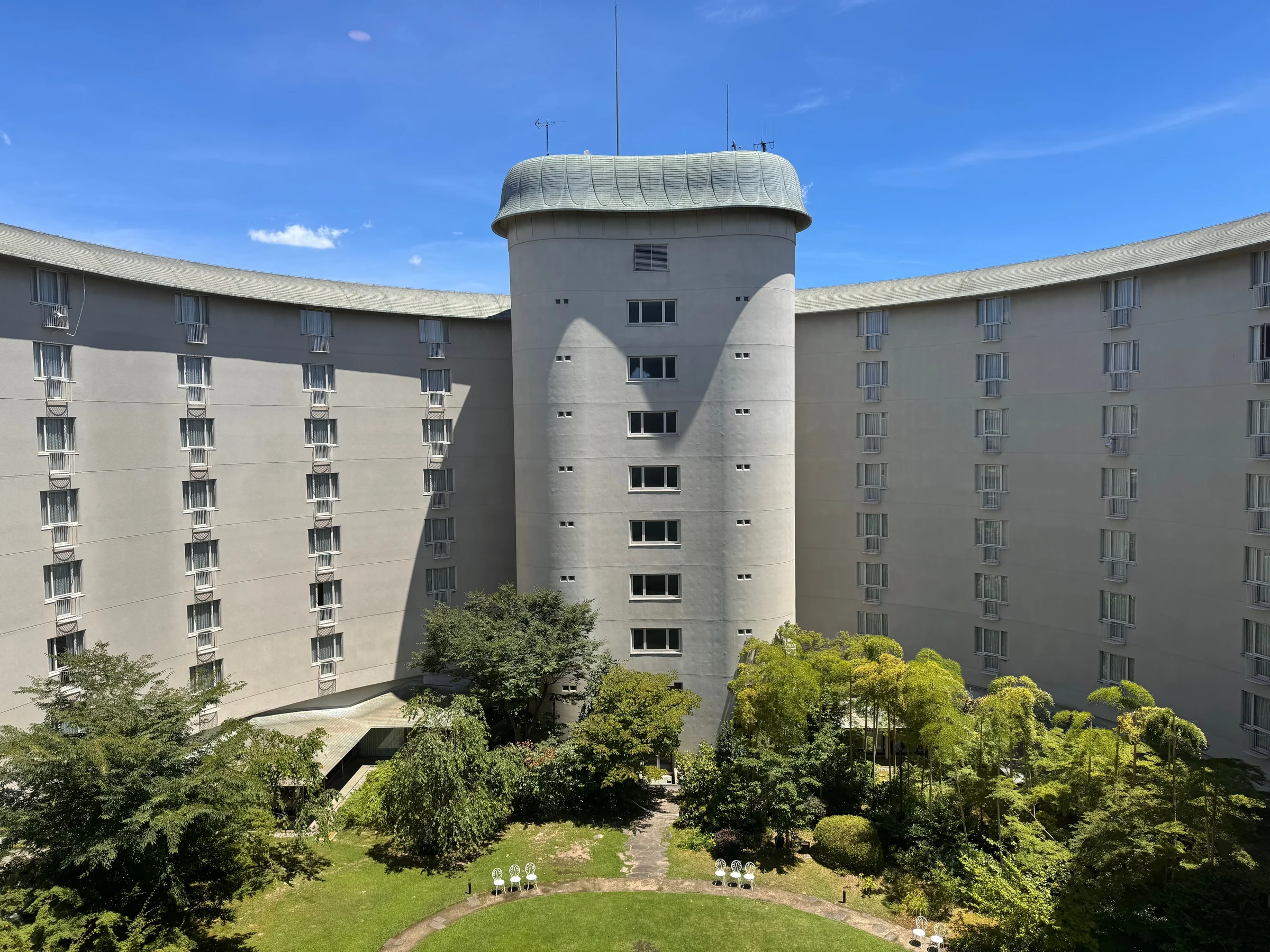 The green courtyard enclosed by the building.