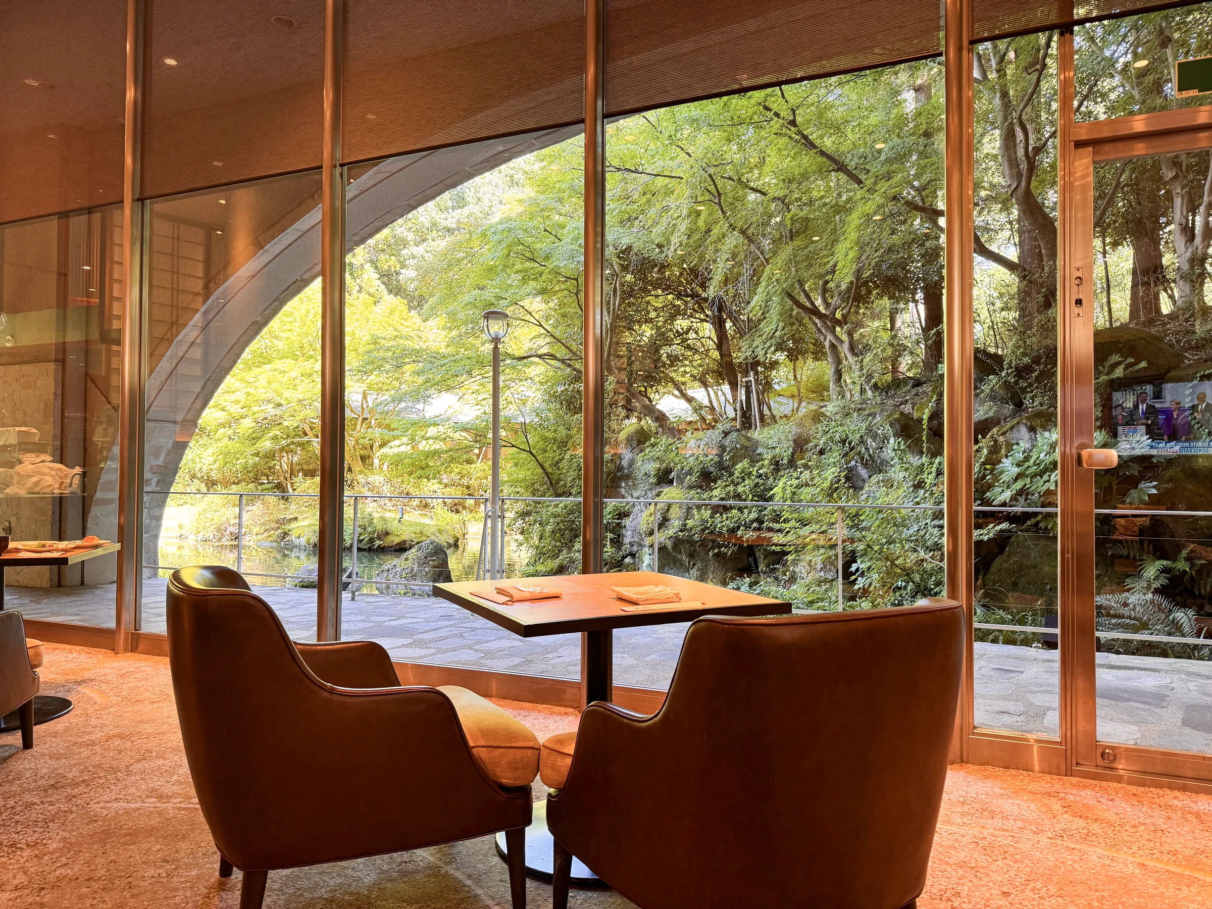 A corner of the lobby with seats overlooking the garden.