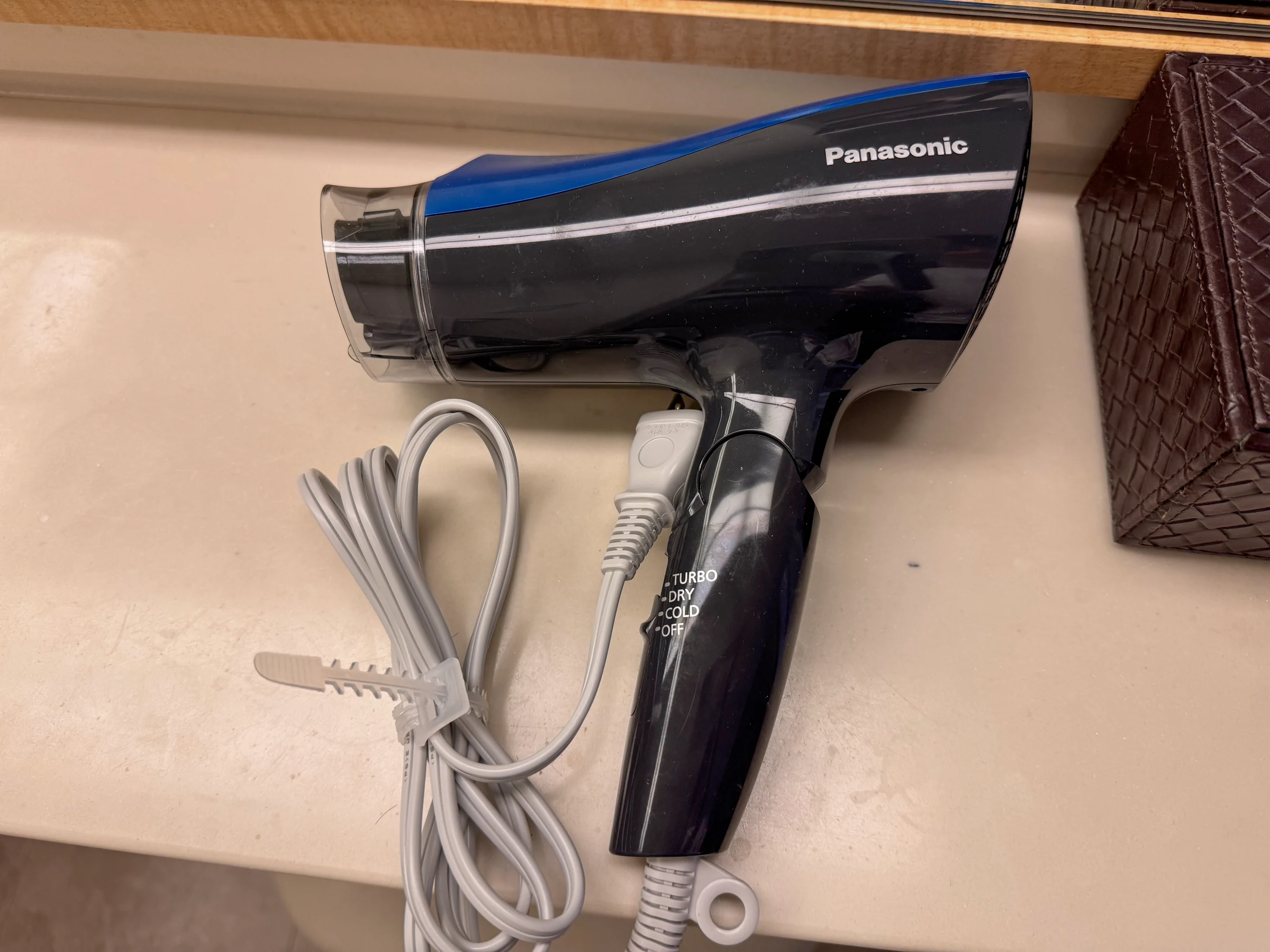 The hair dryer provided in the room.