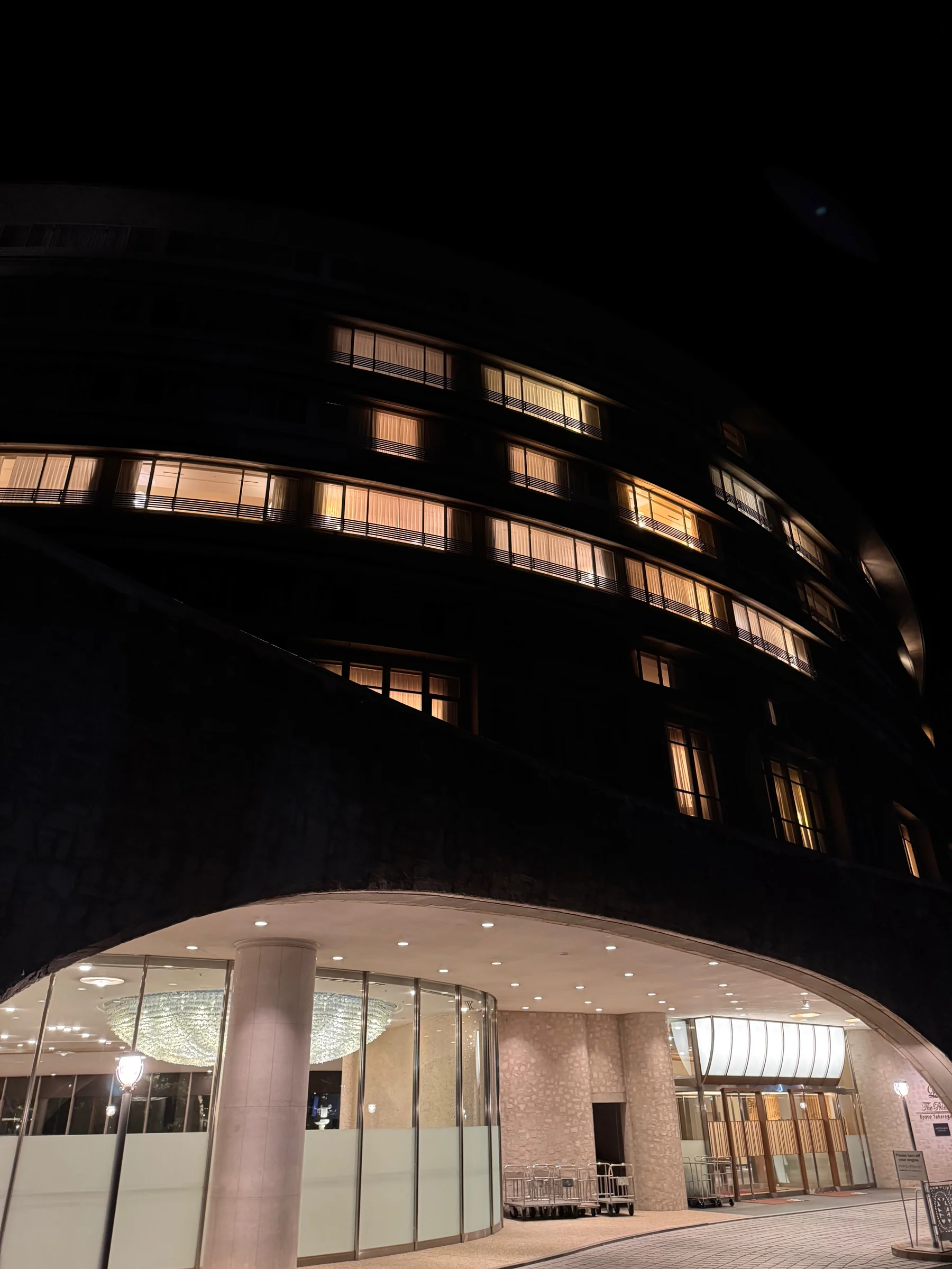 The round hotel illuminated at night.