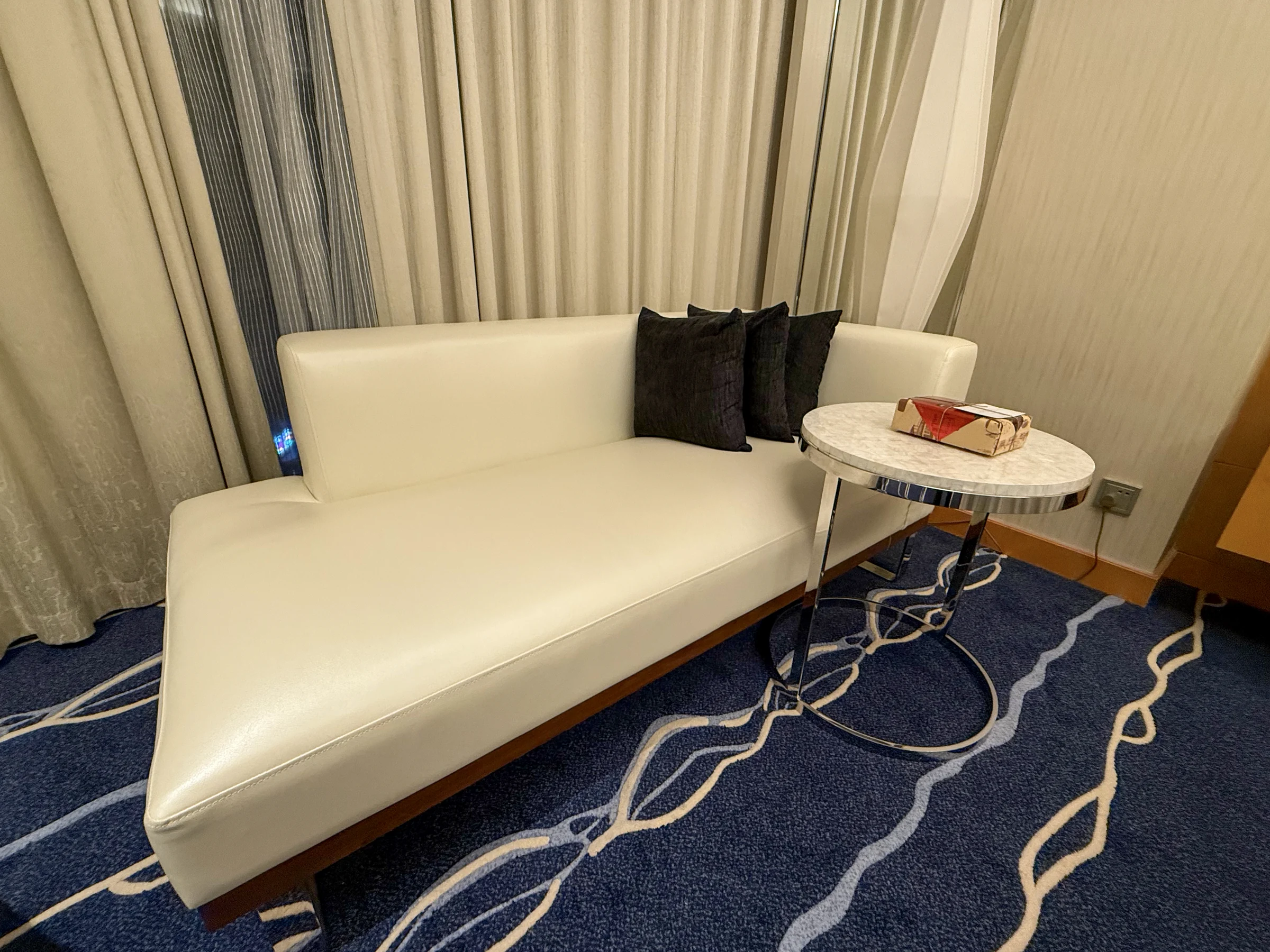 A white sofa by the window.
