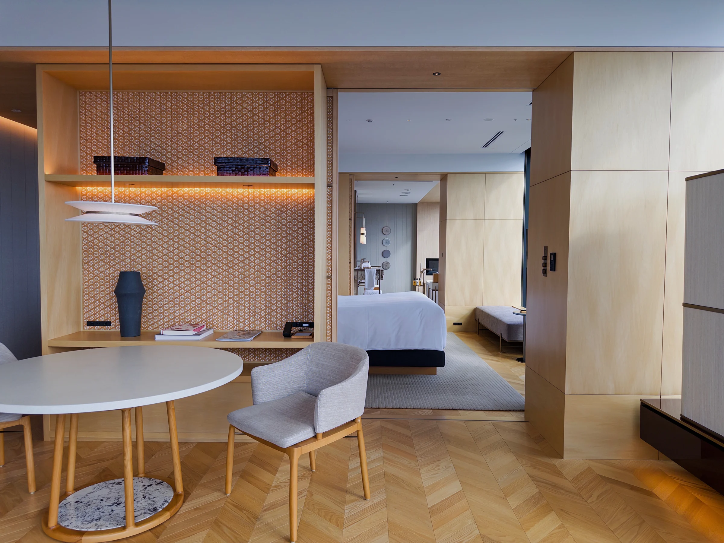 The room, with its dining area leading into the bedroom
