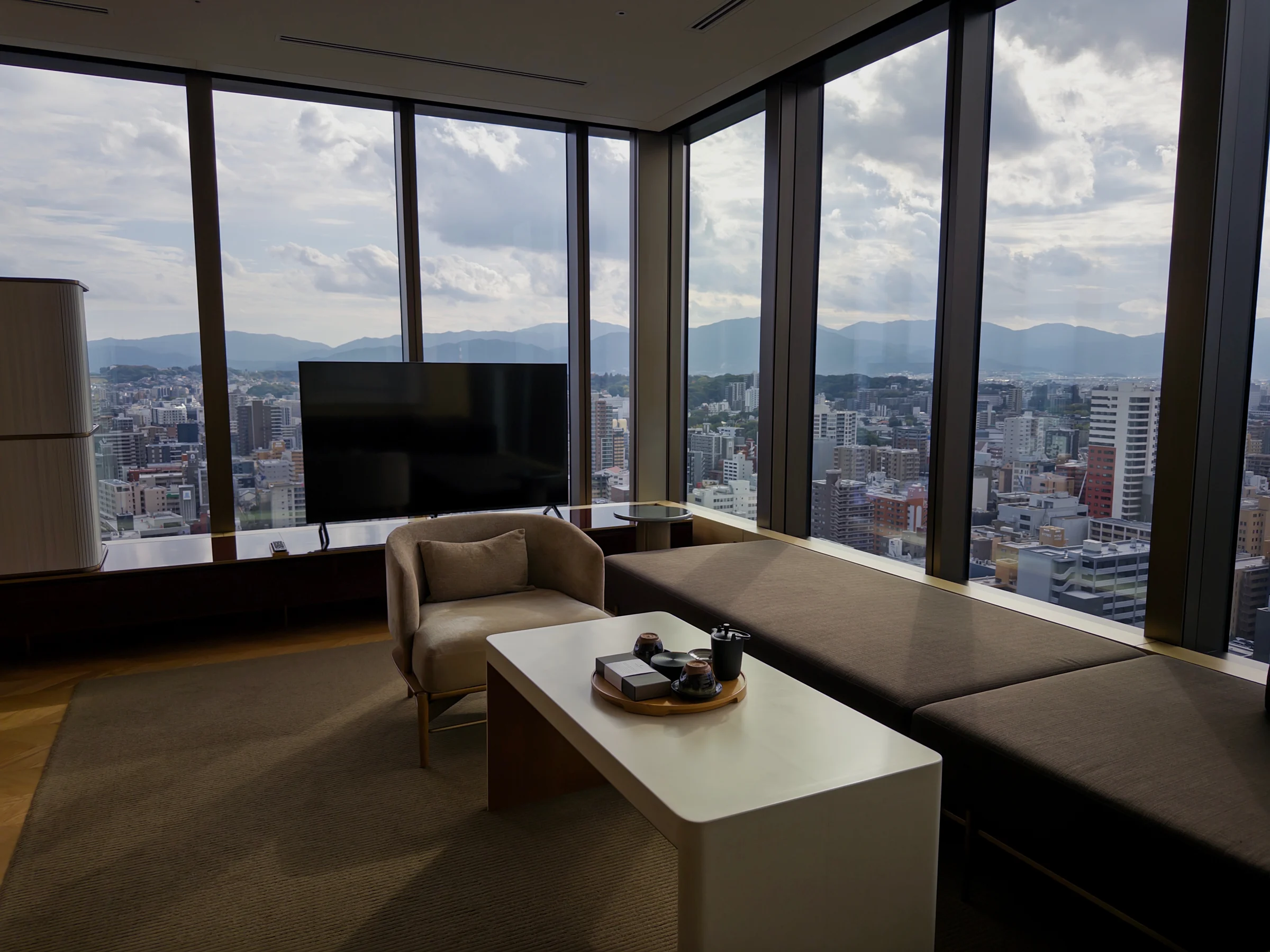 The living area, framed by large corner windows