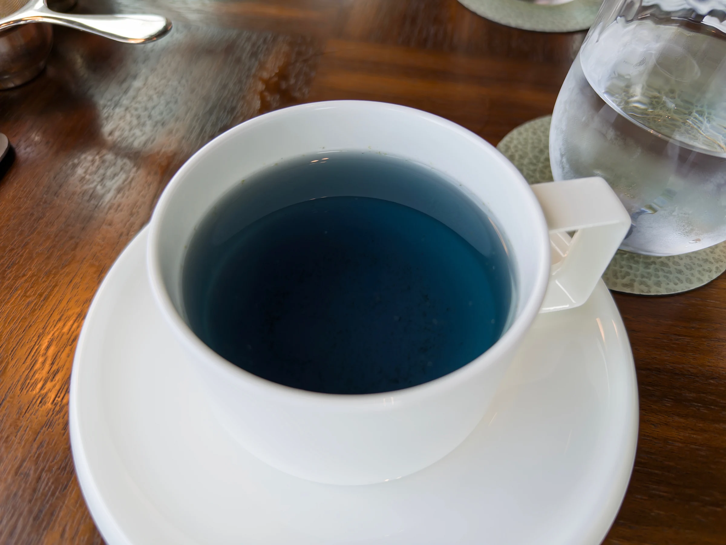 Blue tea and a white teacup