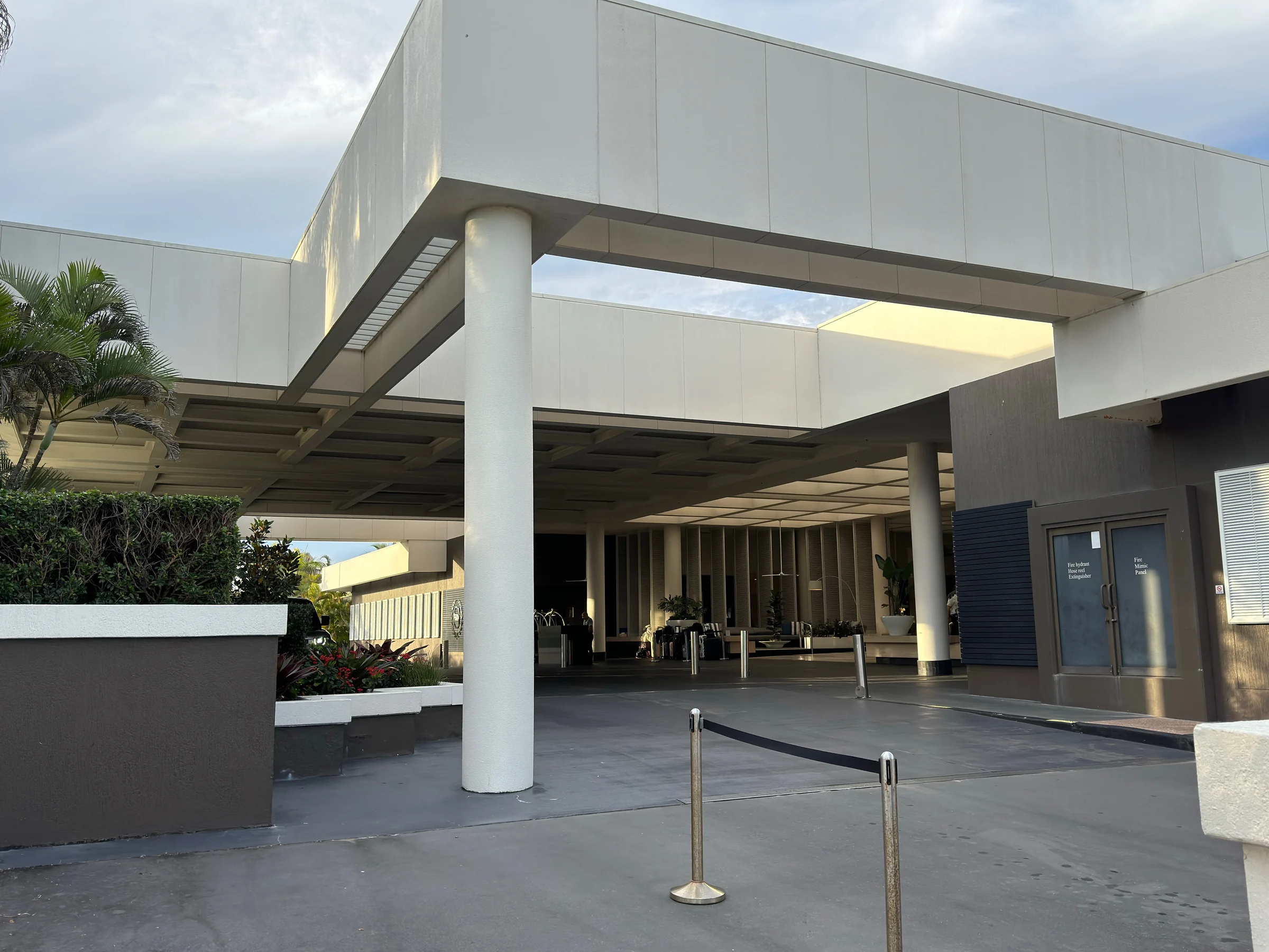 The white driveway canopy and hotel entrance.