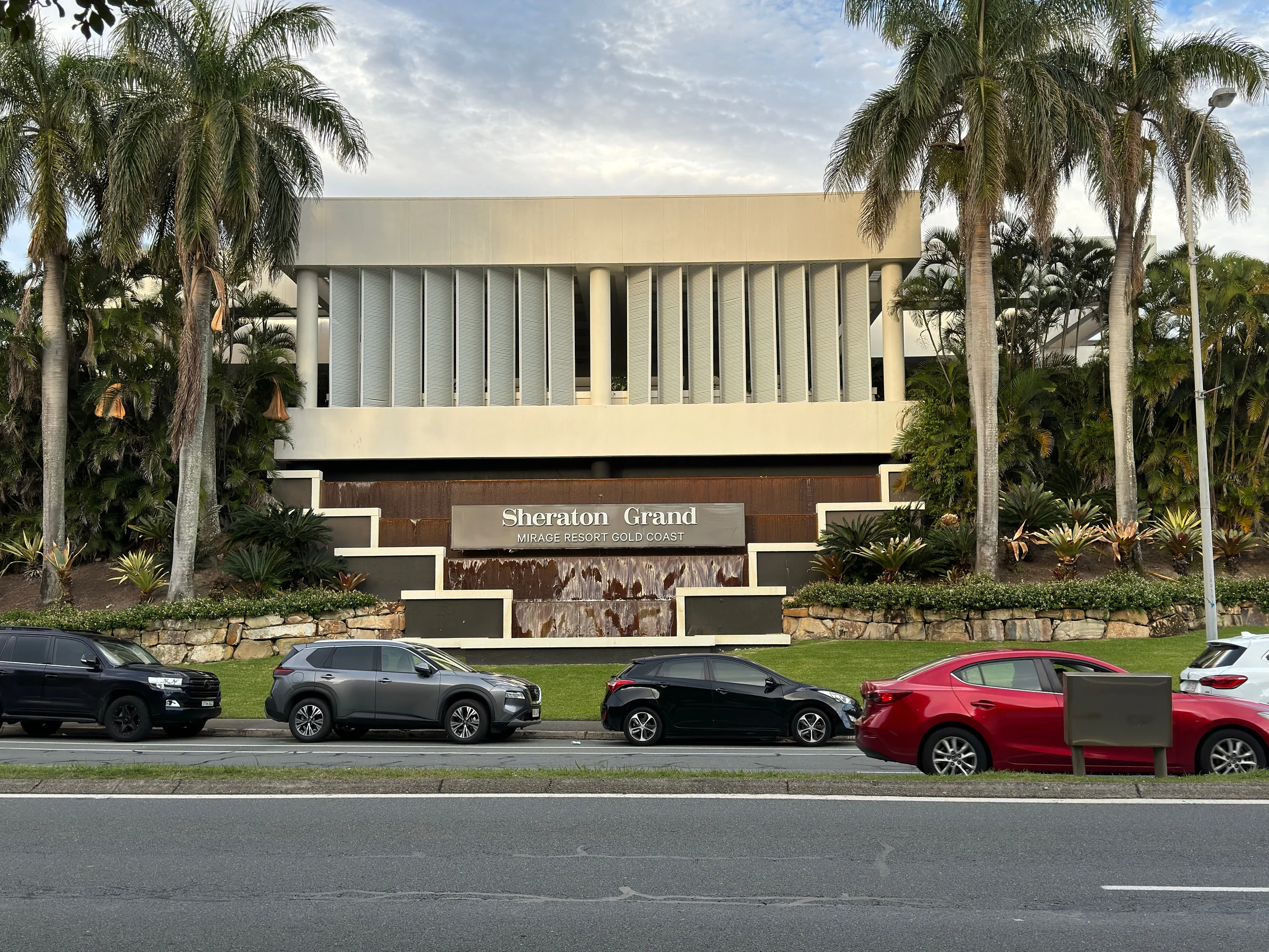 Palm trees along the hotel exterior.