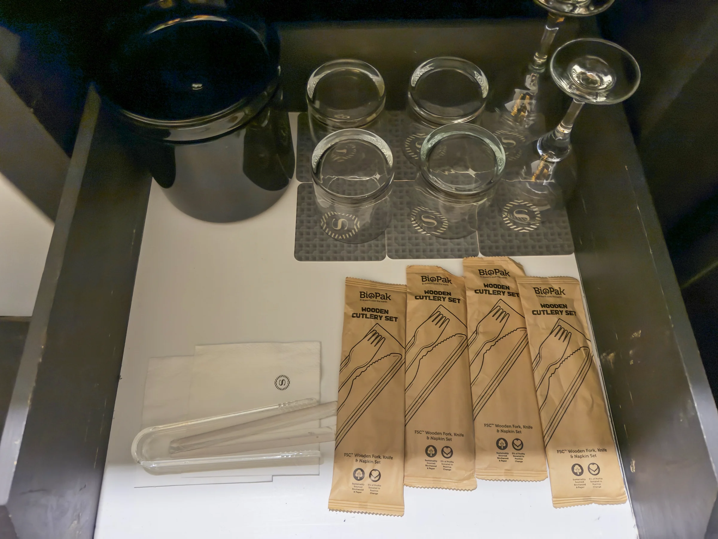 Cups, glasses and wooden cutlery.
