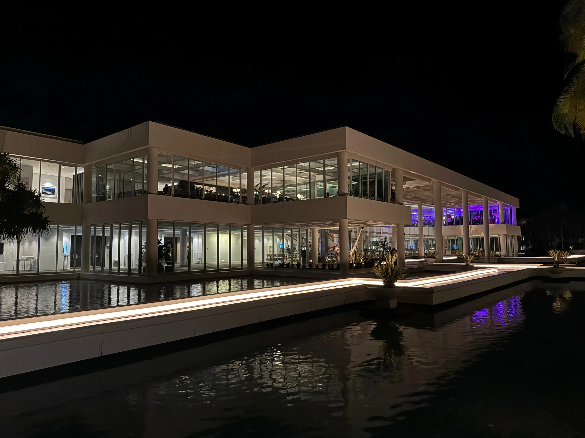 The resort reflected on the water at night.