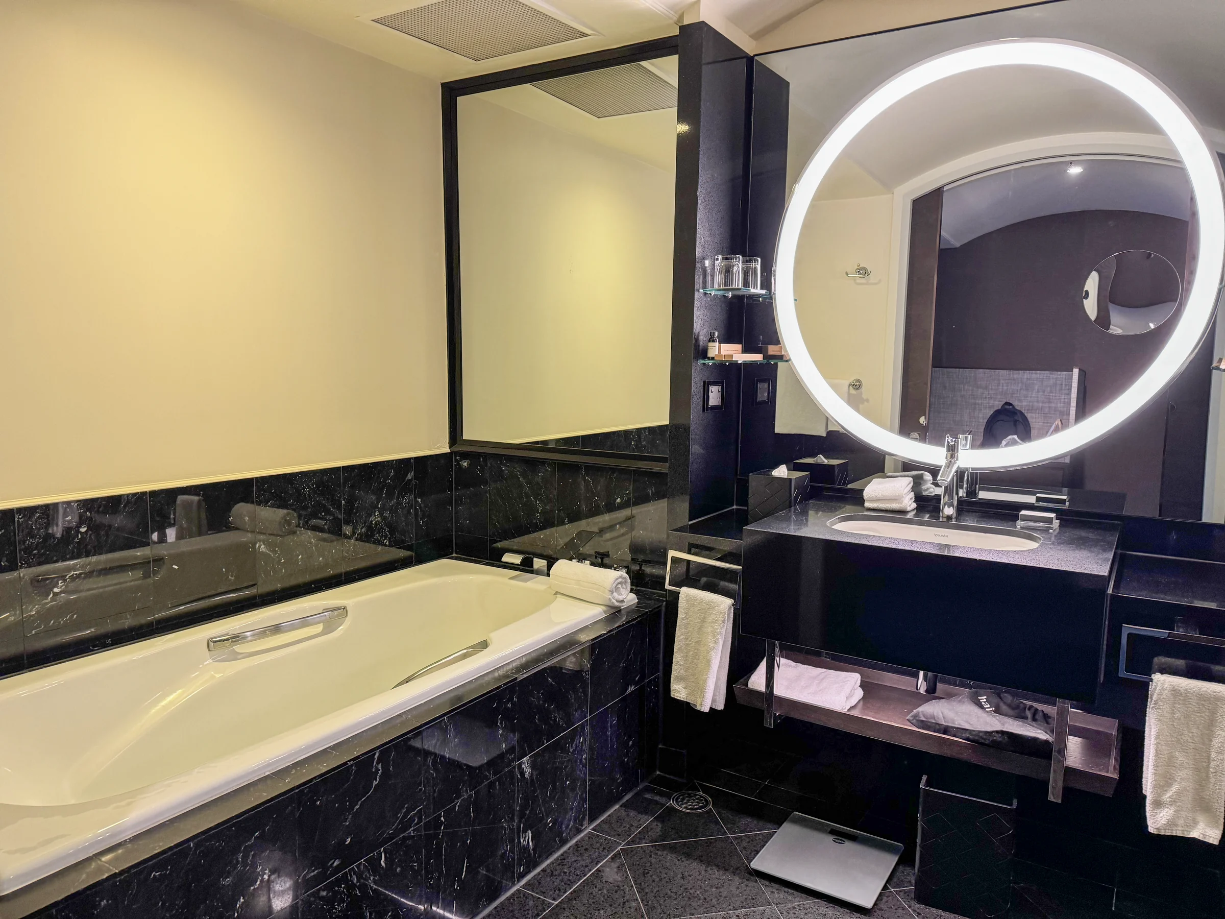 The bathtub beside the vanity.