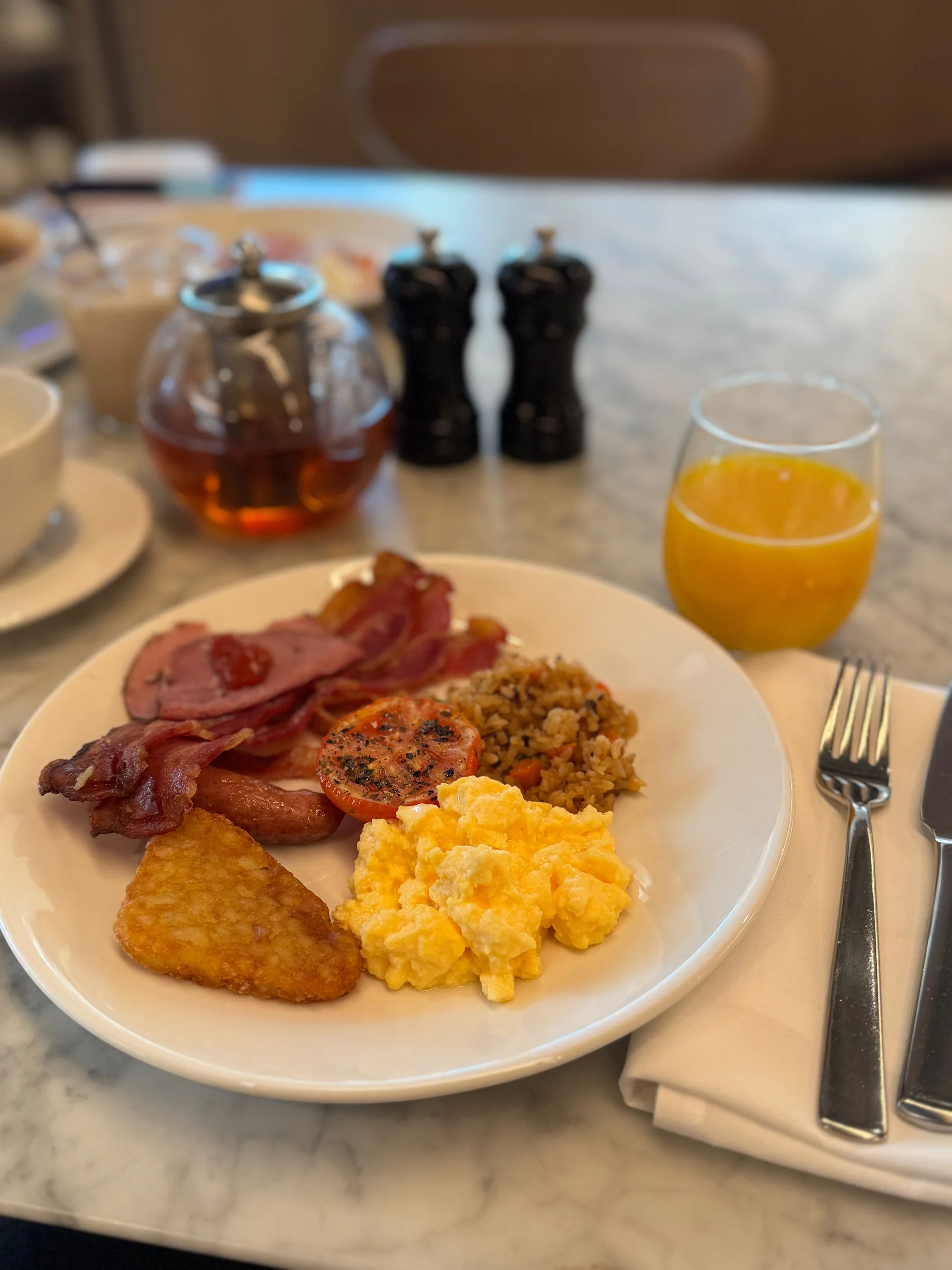 Breakfast with eggs, bacon and other dishes.