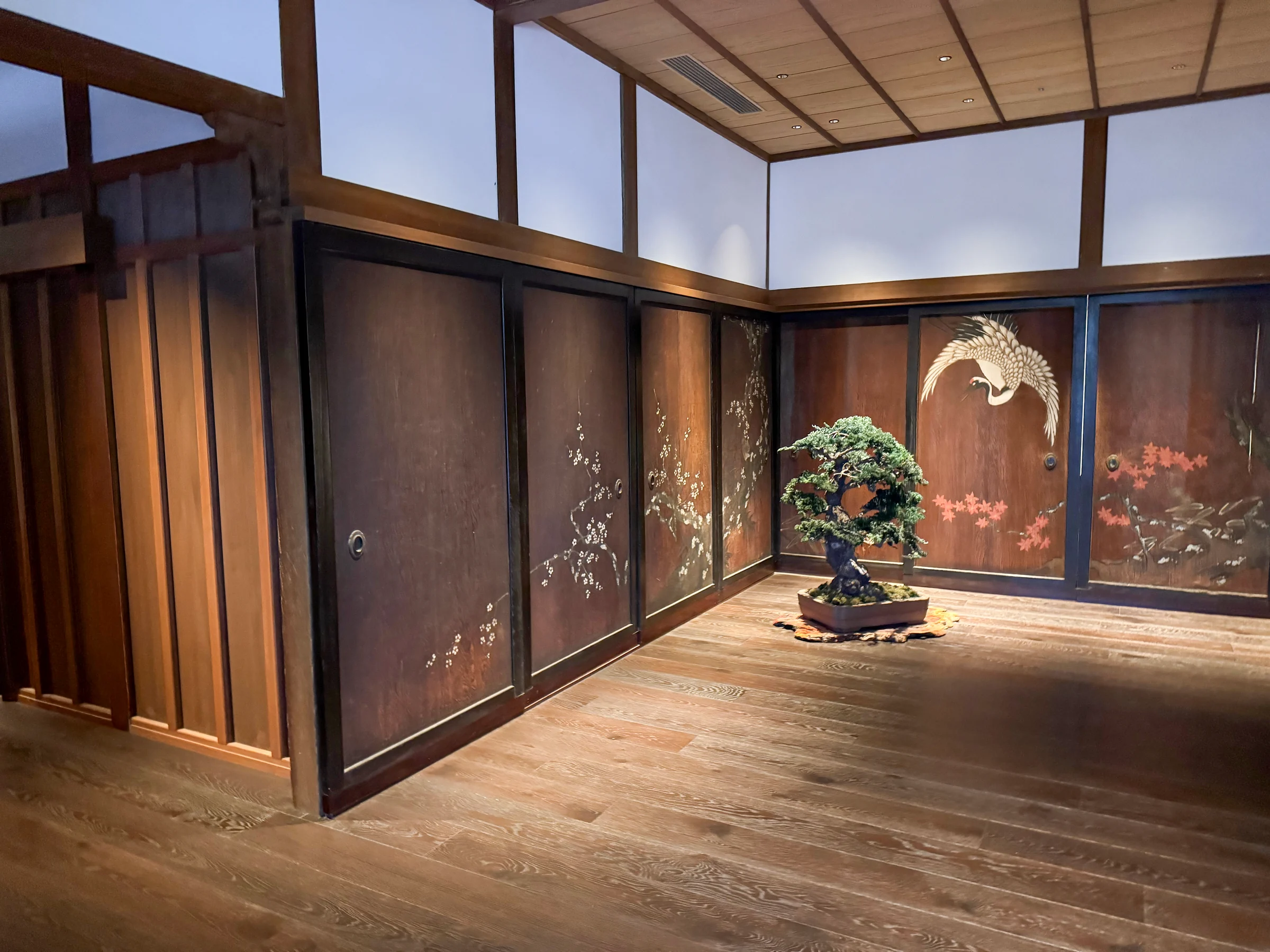Crane paintings and bonsai at reception.