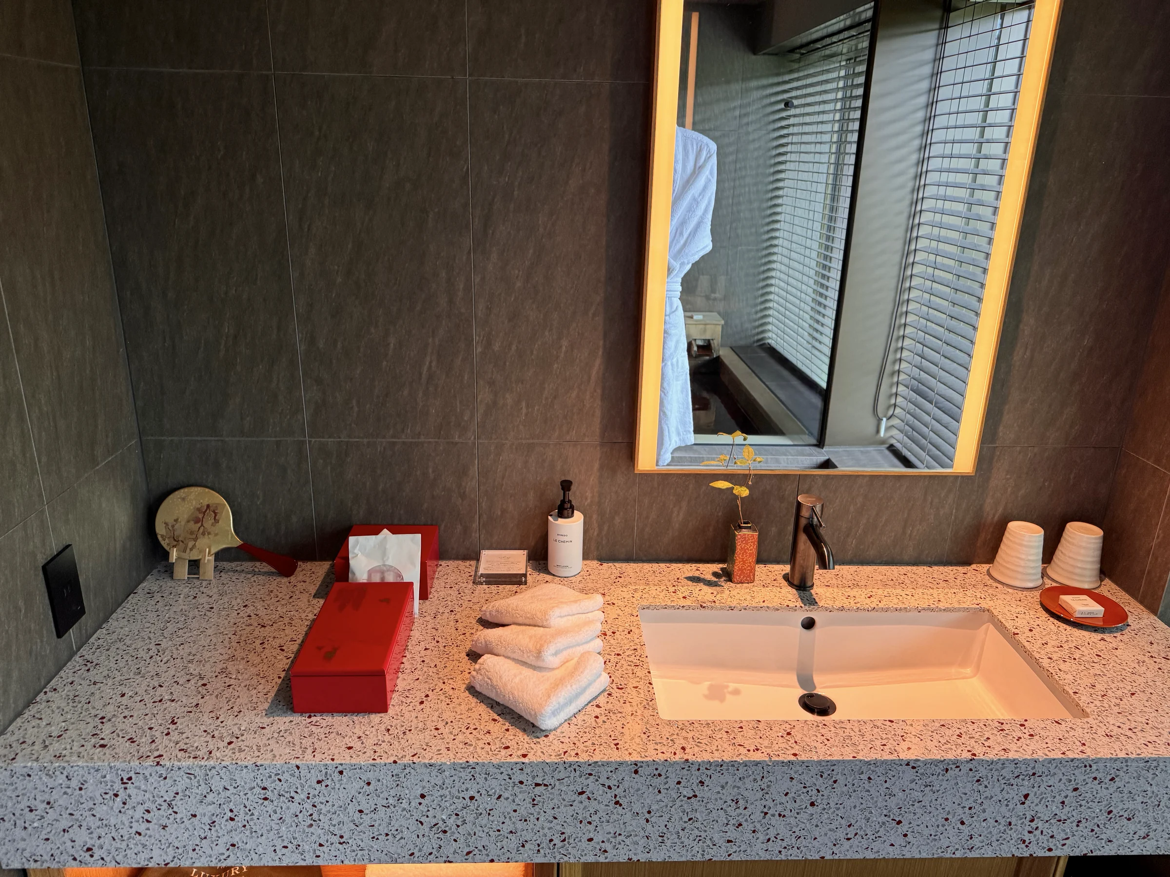 The in-room hot spring beyond the vanity area.