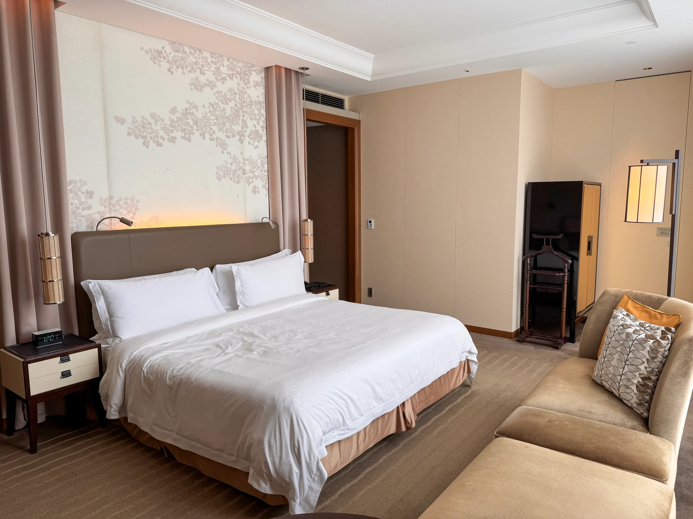 The Grand Deluxe room at The St. Regis Osaka, with a king bed and beige sofa