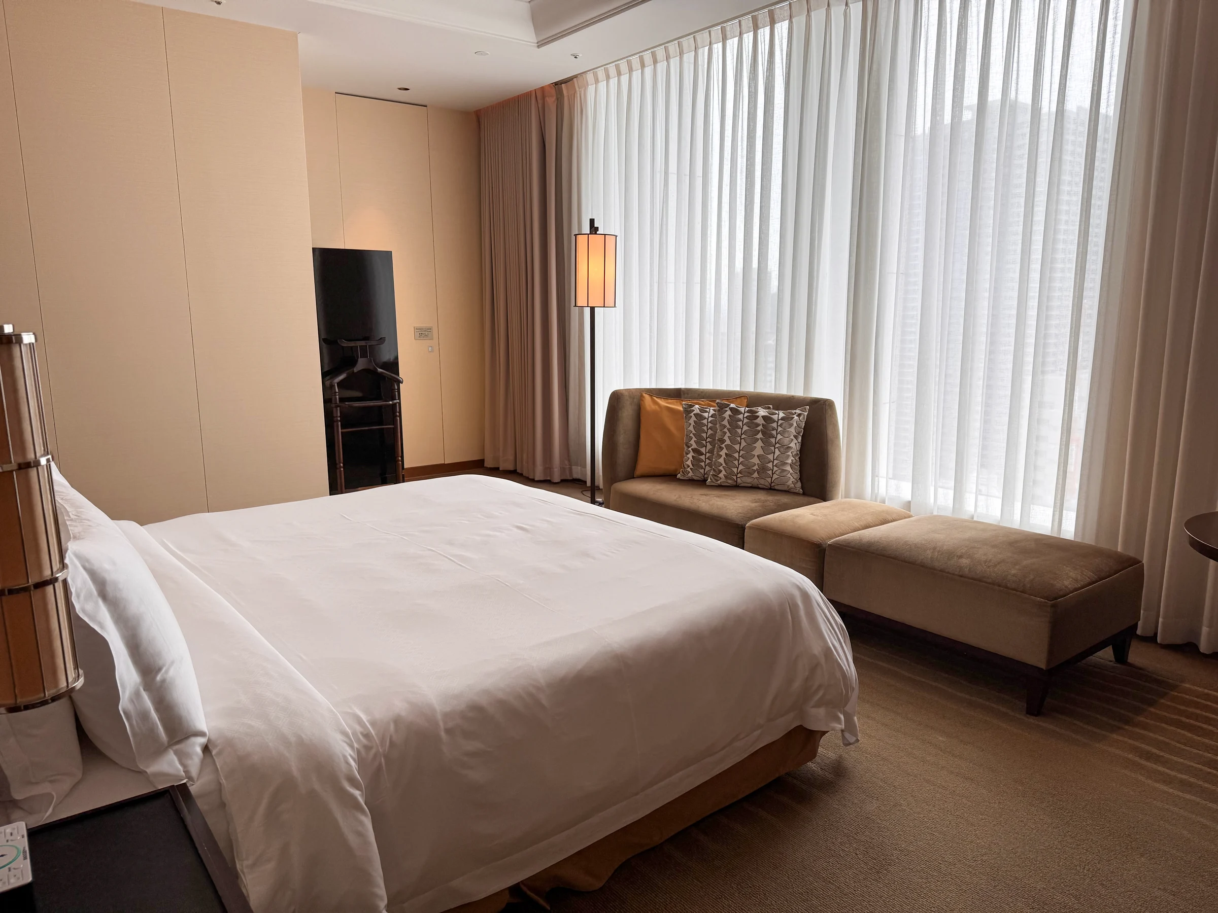 Large windows and calm colours in the room.