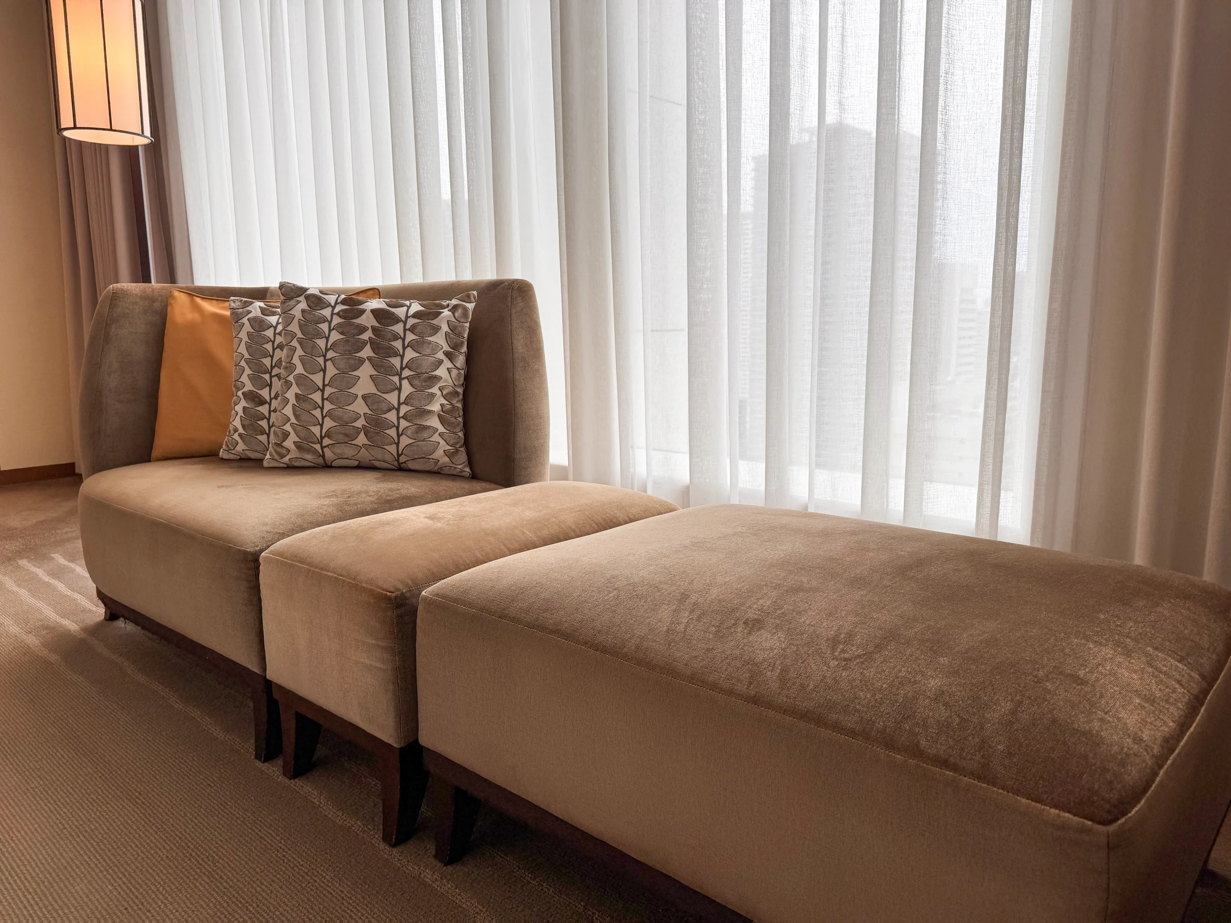 A long sofa beside the window.