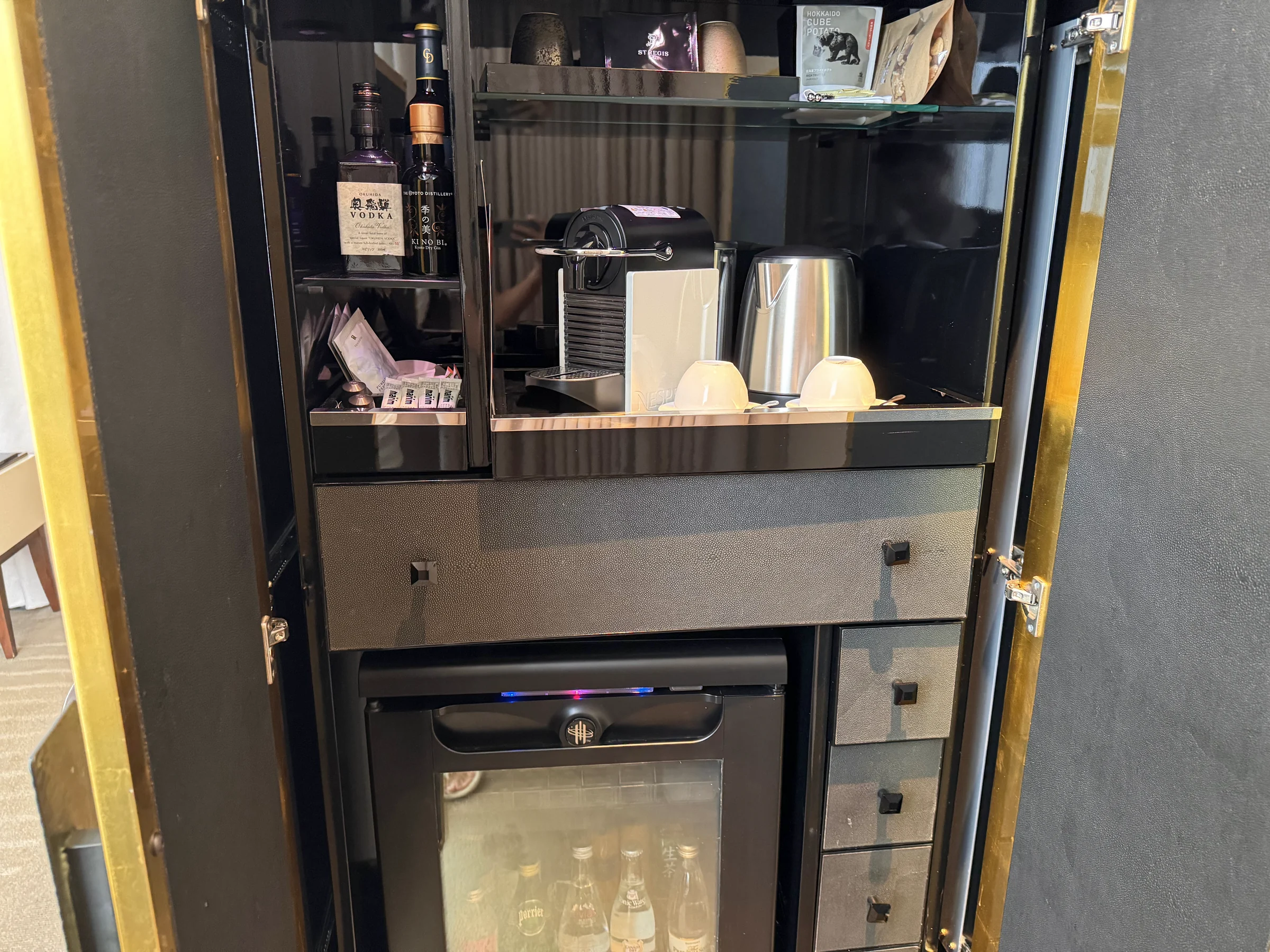 Opening the doors to the minibar.