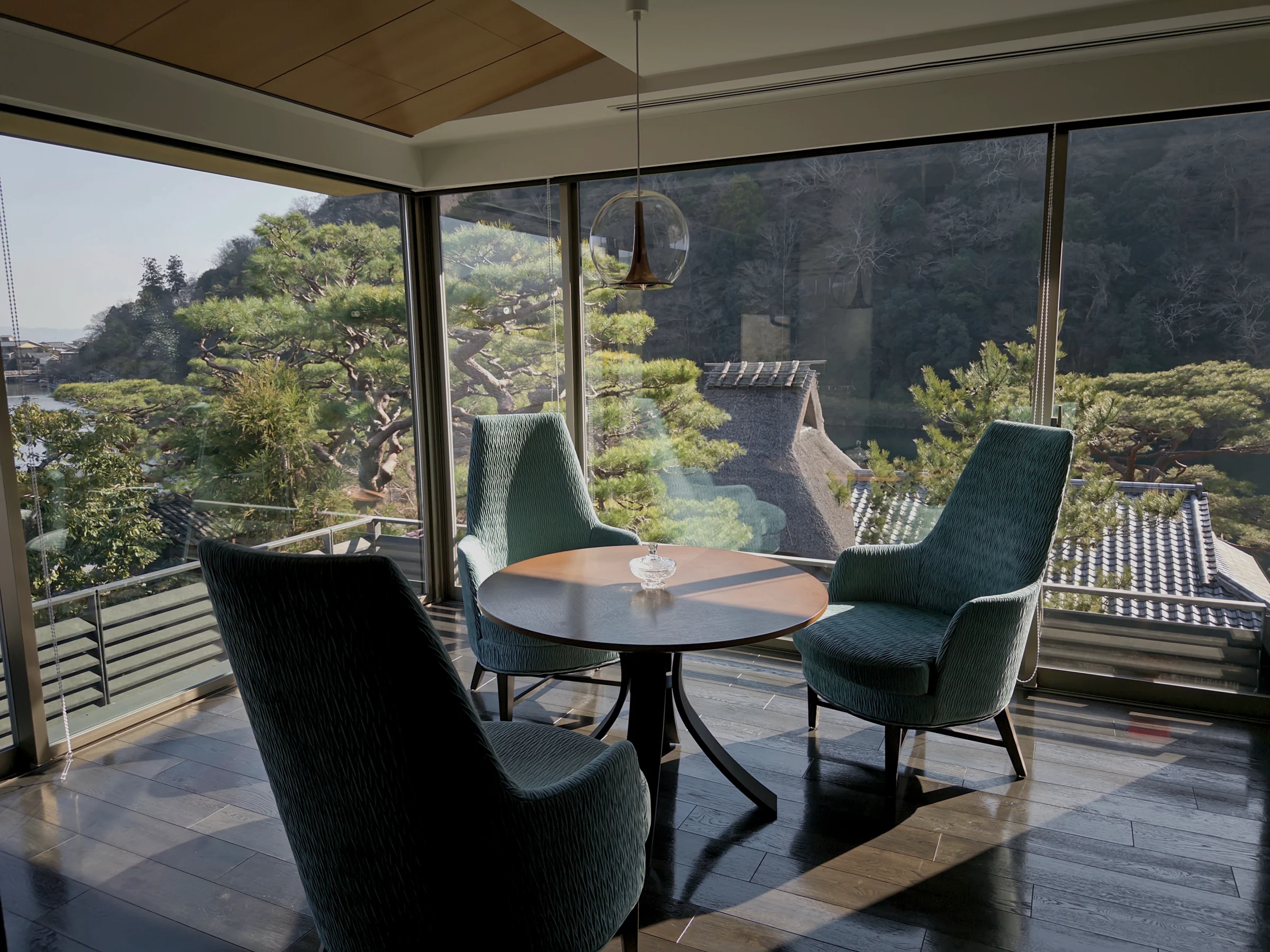 A window-side table and chairs overlooking Arashiyama