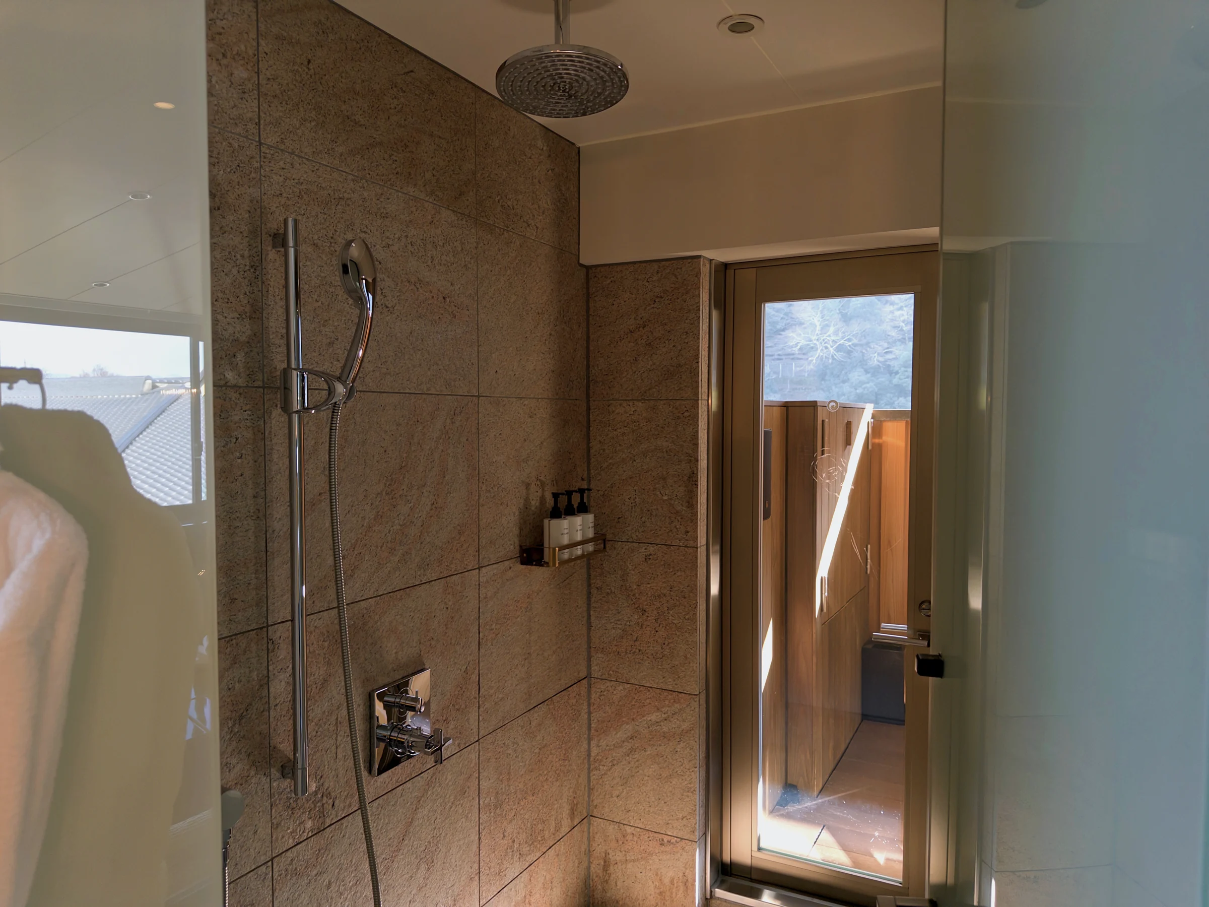 A shower area surrounded by stone walls
