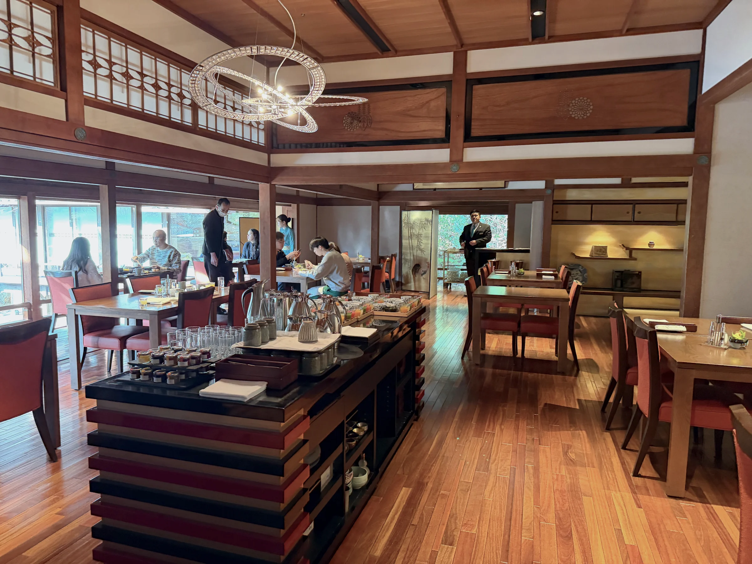 A dining room with wooden beams and large lights