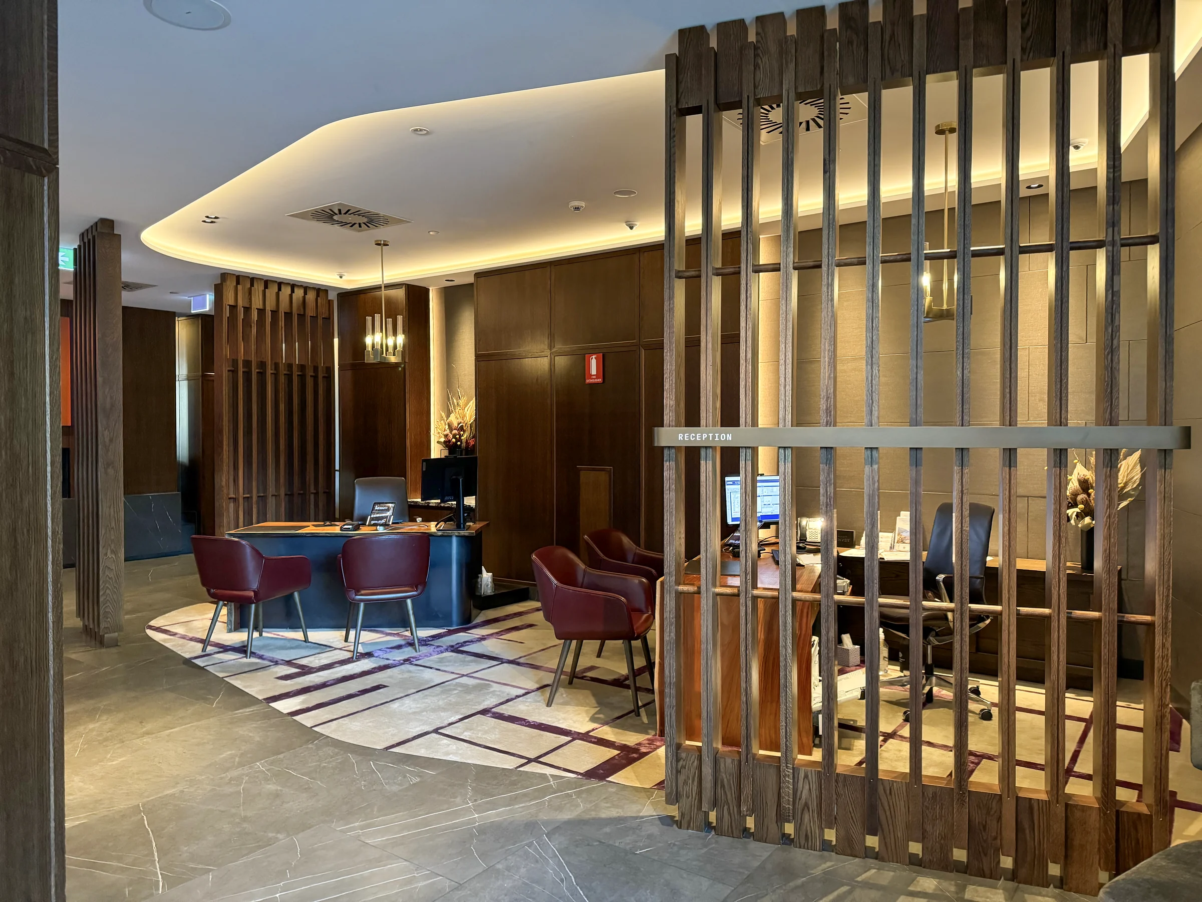 The lobby surrounded by wooden screens.