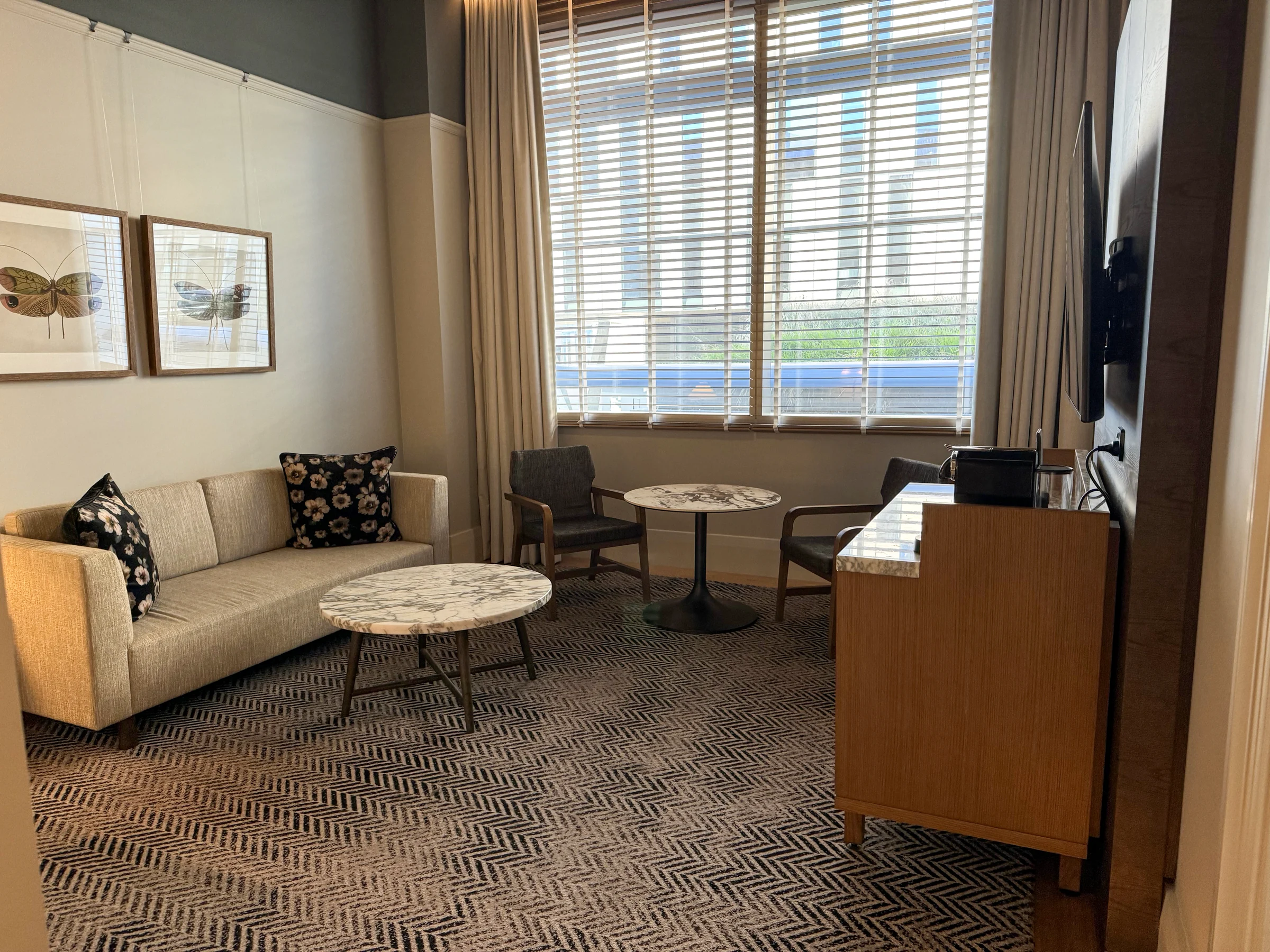 The living room of The Tasman Hobart's Heritage Suite, with large windows