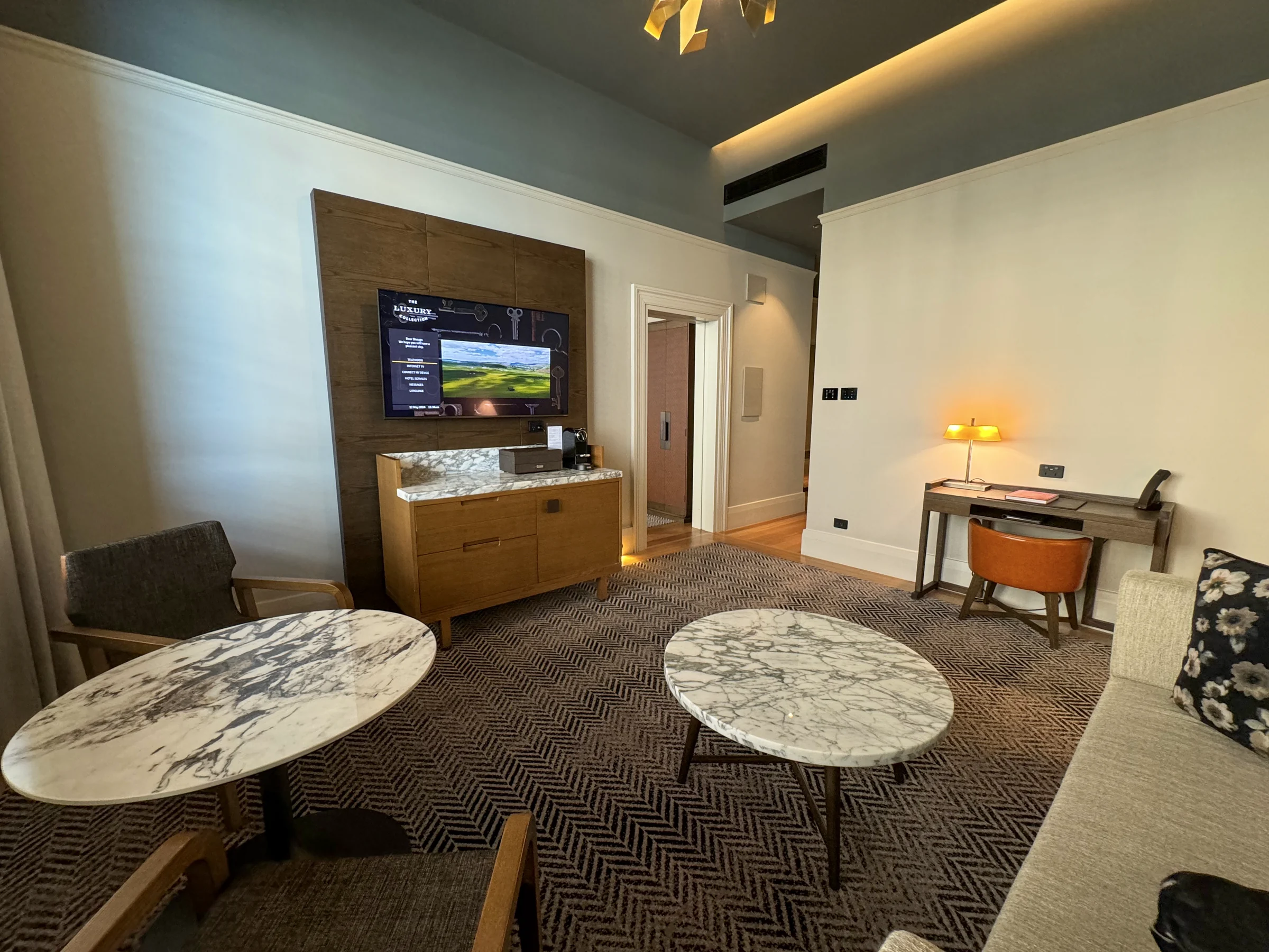 A corner with a television and round table.