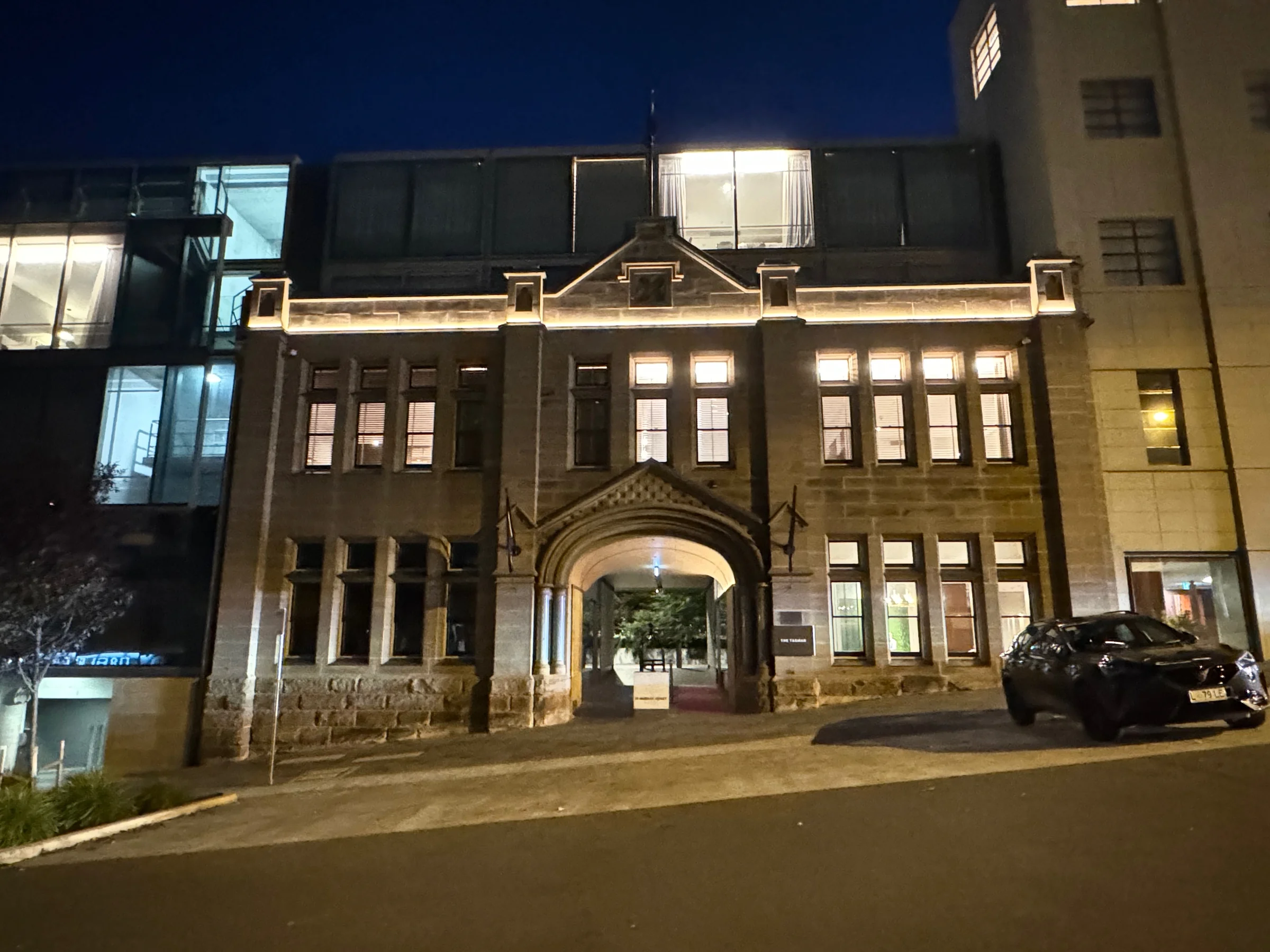 The main entrance lit up at night.