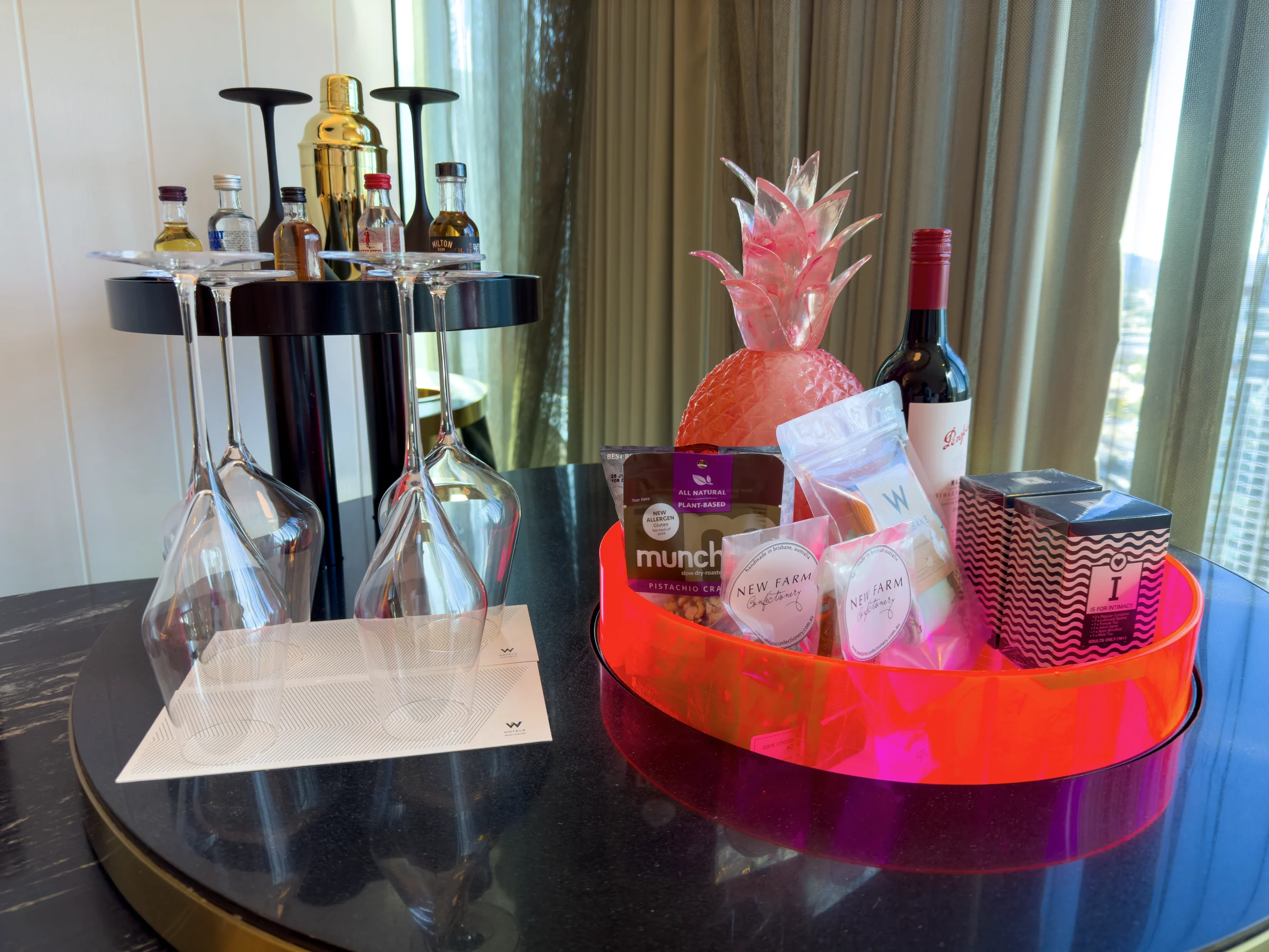 A red-lit minibar and colorful snacks.