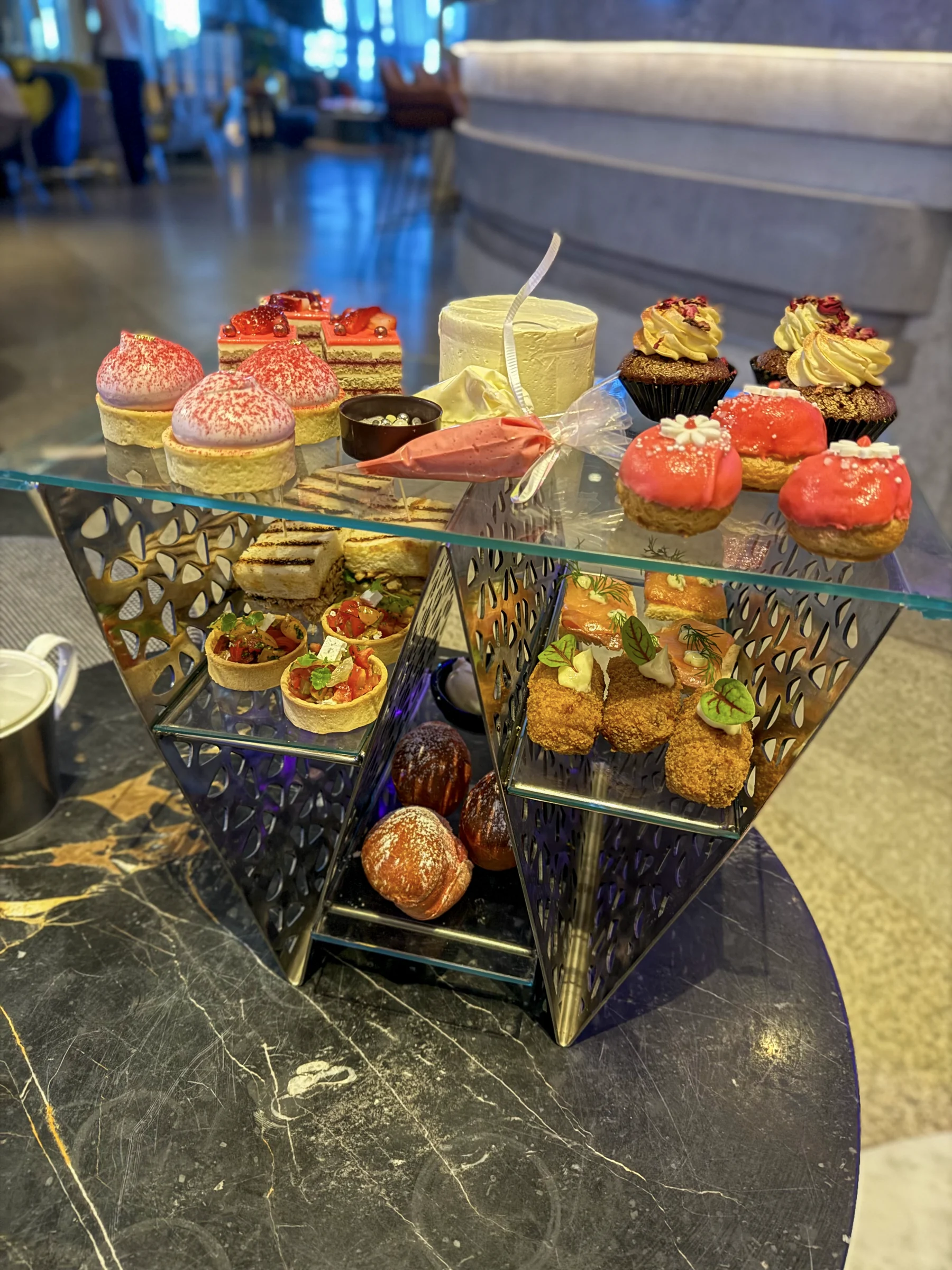 High tea on a W-shaped stand.