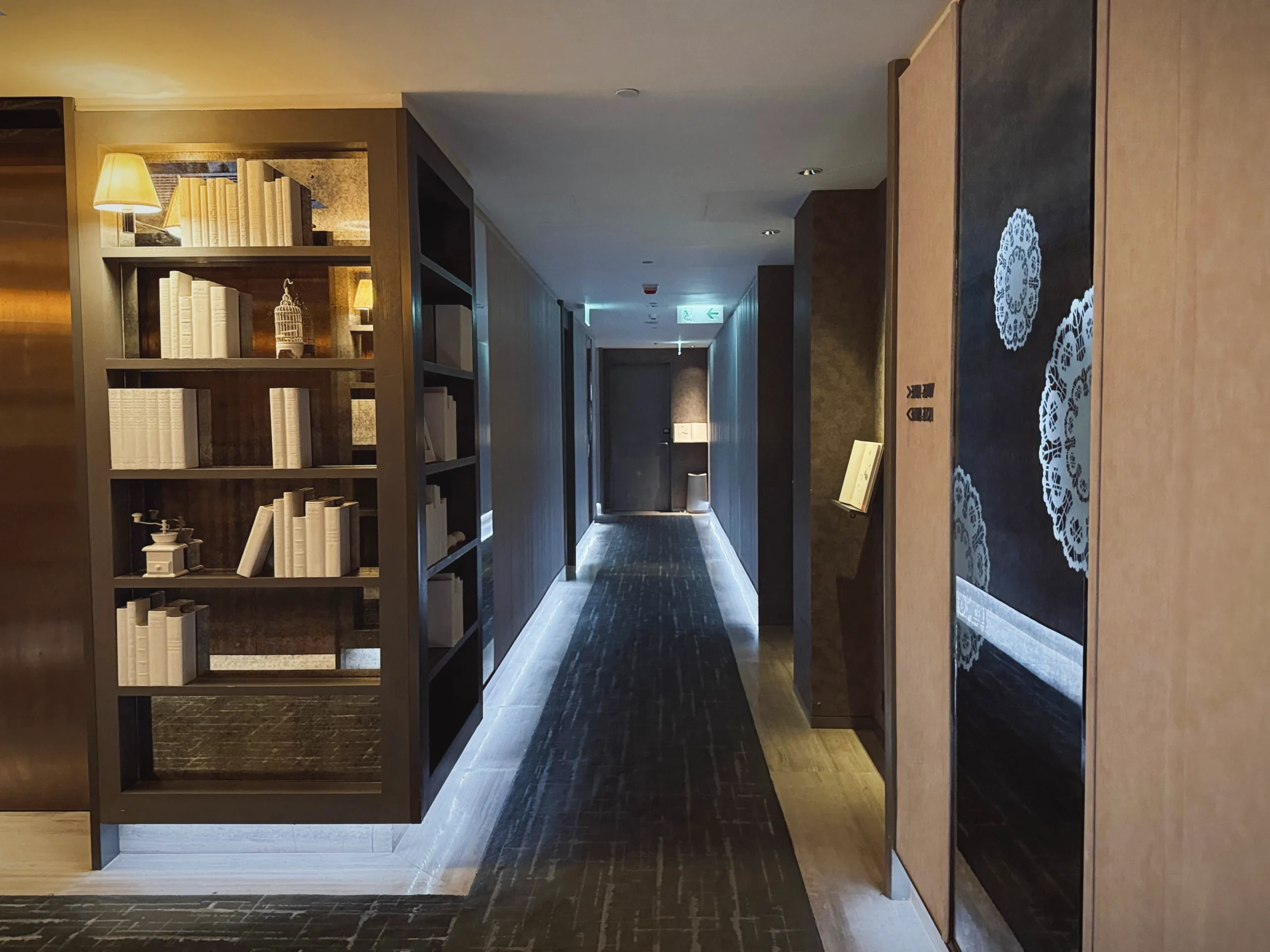 Bookshelves and a corridor on the guest floor.