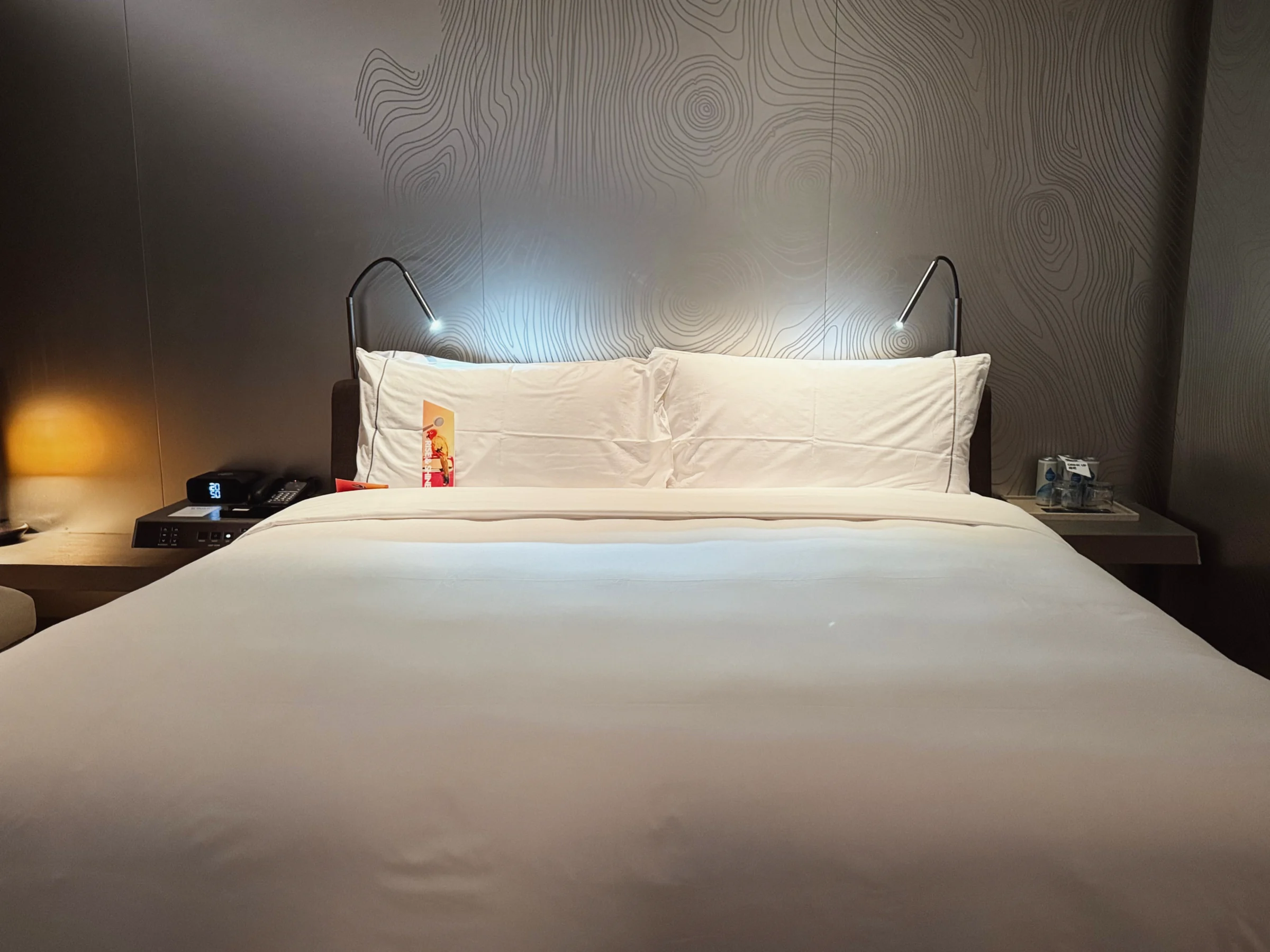 The king bed and bedside lighting.