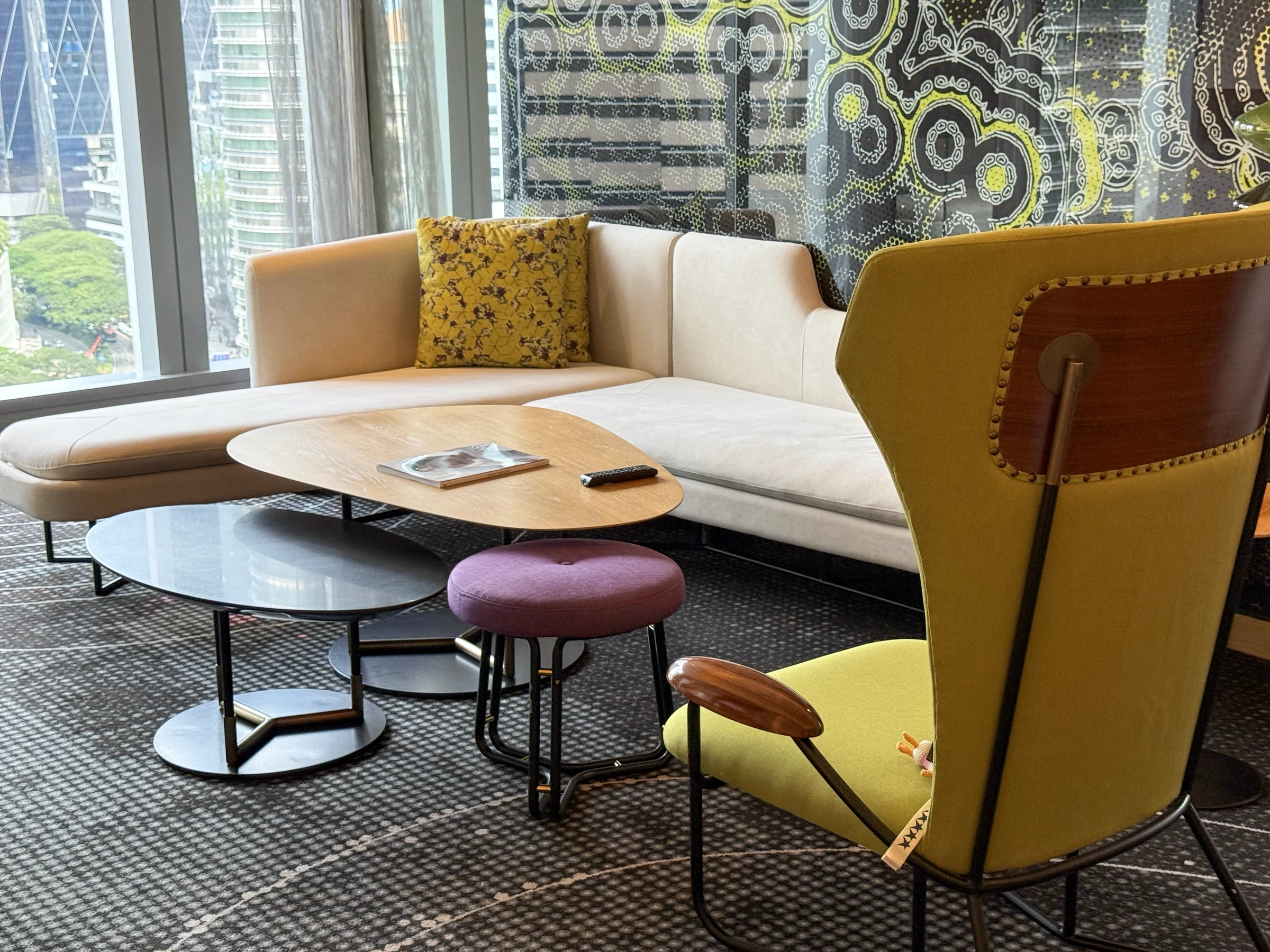 A chair and sofa by the window.