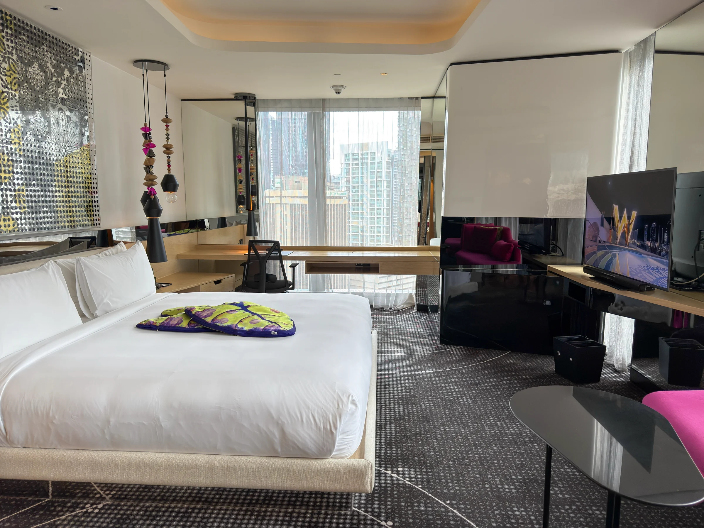 W Kuala Lumpur's 18th-floor Marvelous Suite, with a window-side desk and king bed