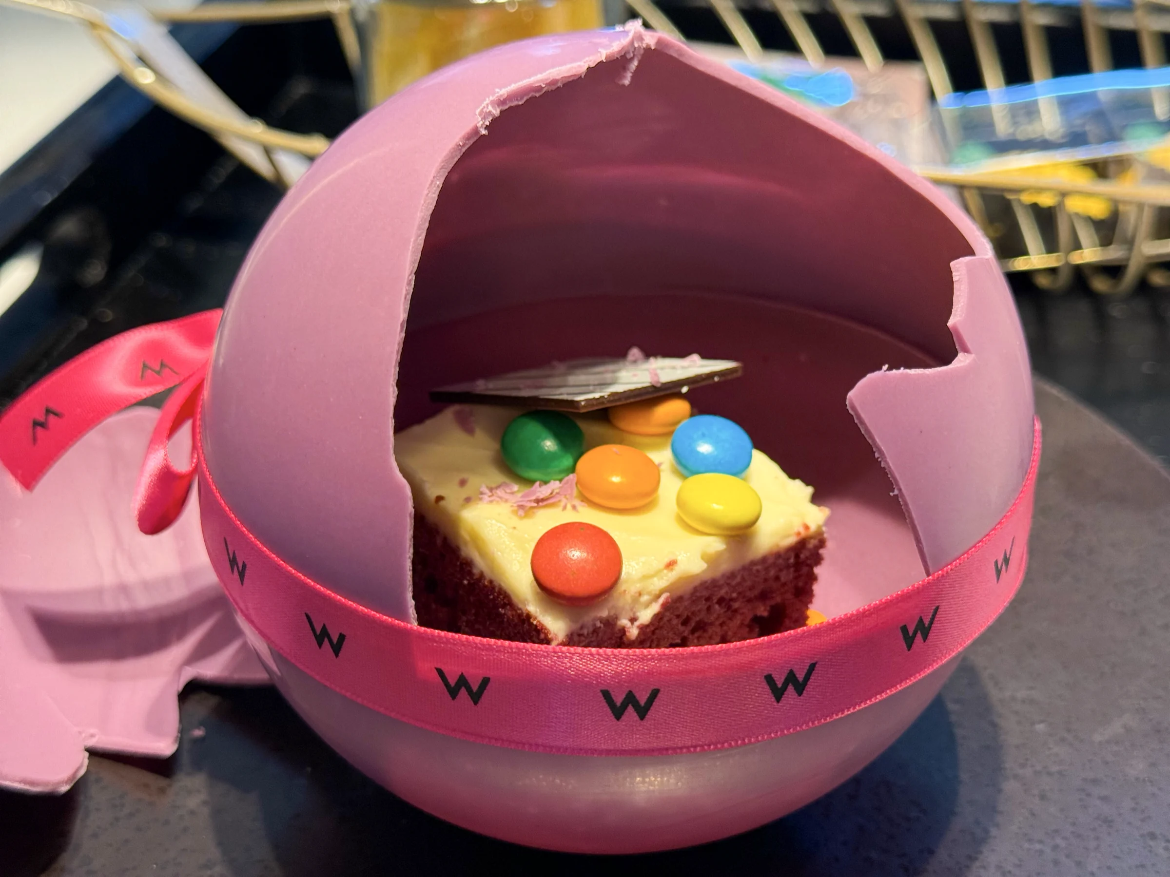 Breaking the chocolate sphere revealed a cake inside.