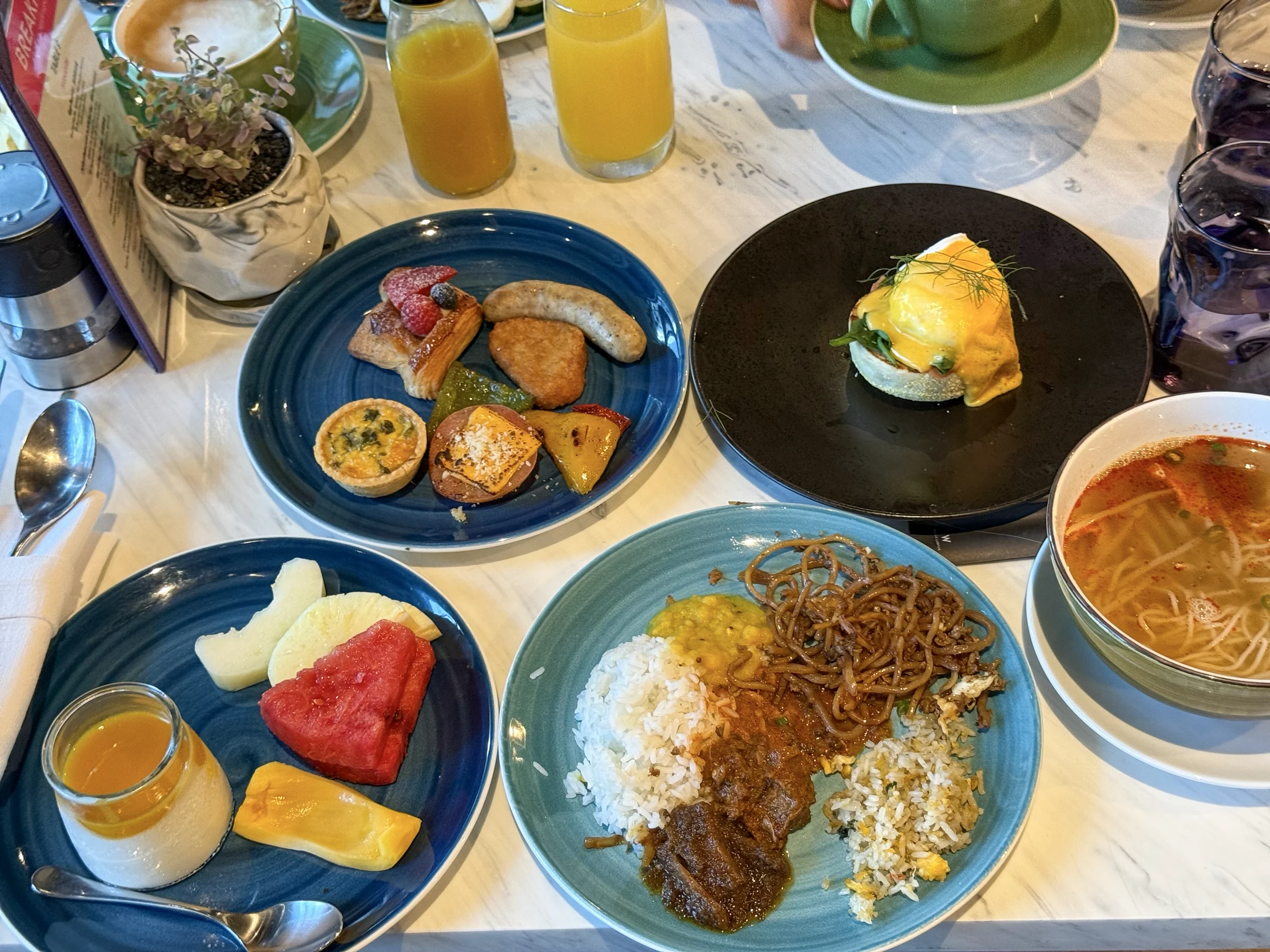Breakfast with eggs Benedict and noodles.