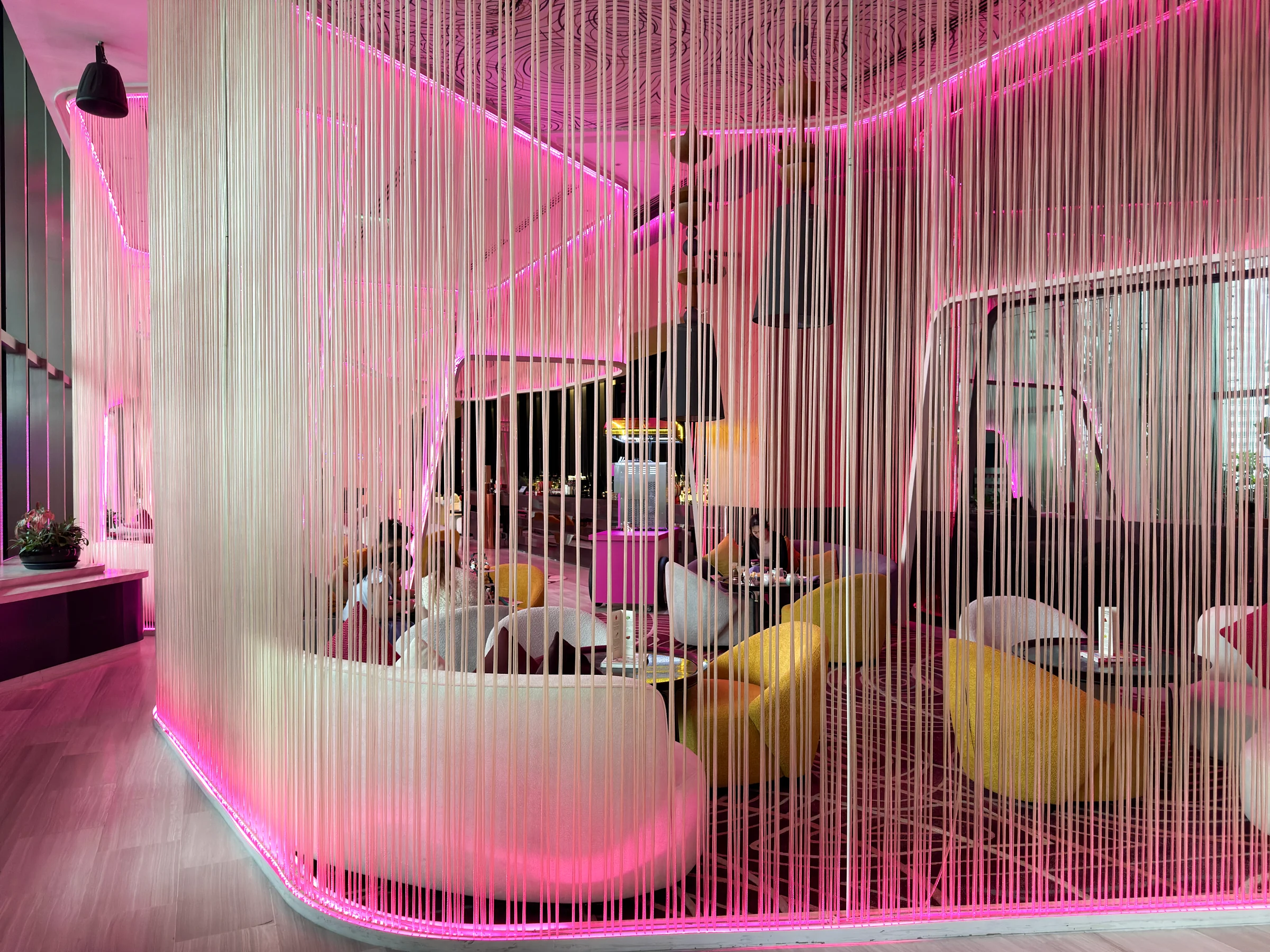 W Living Room bathed in pink light.