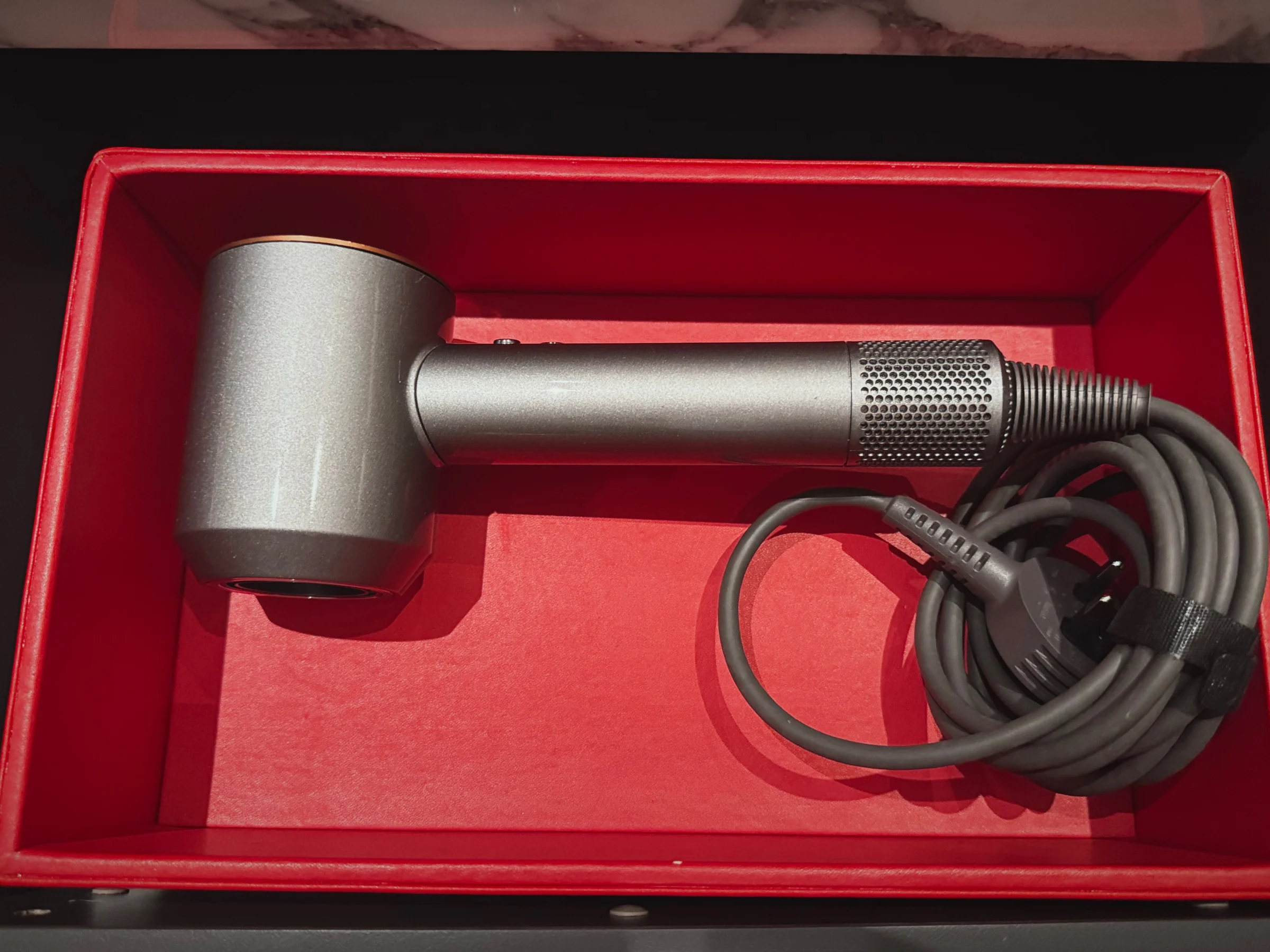 The hair dryer in a red drawer