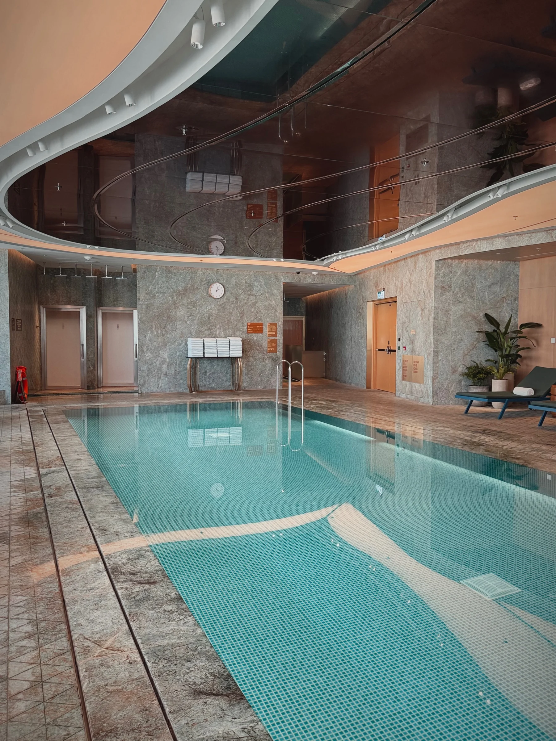 A bright indoor pool and curved ceiling