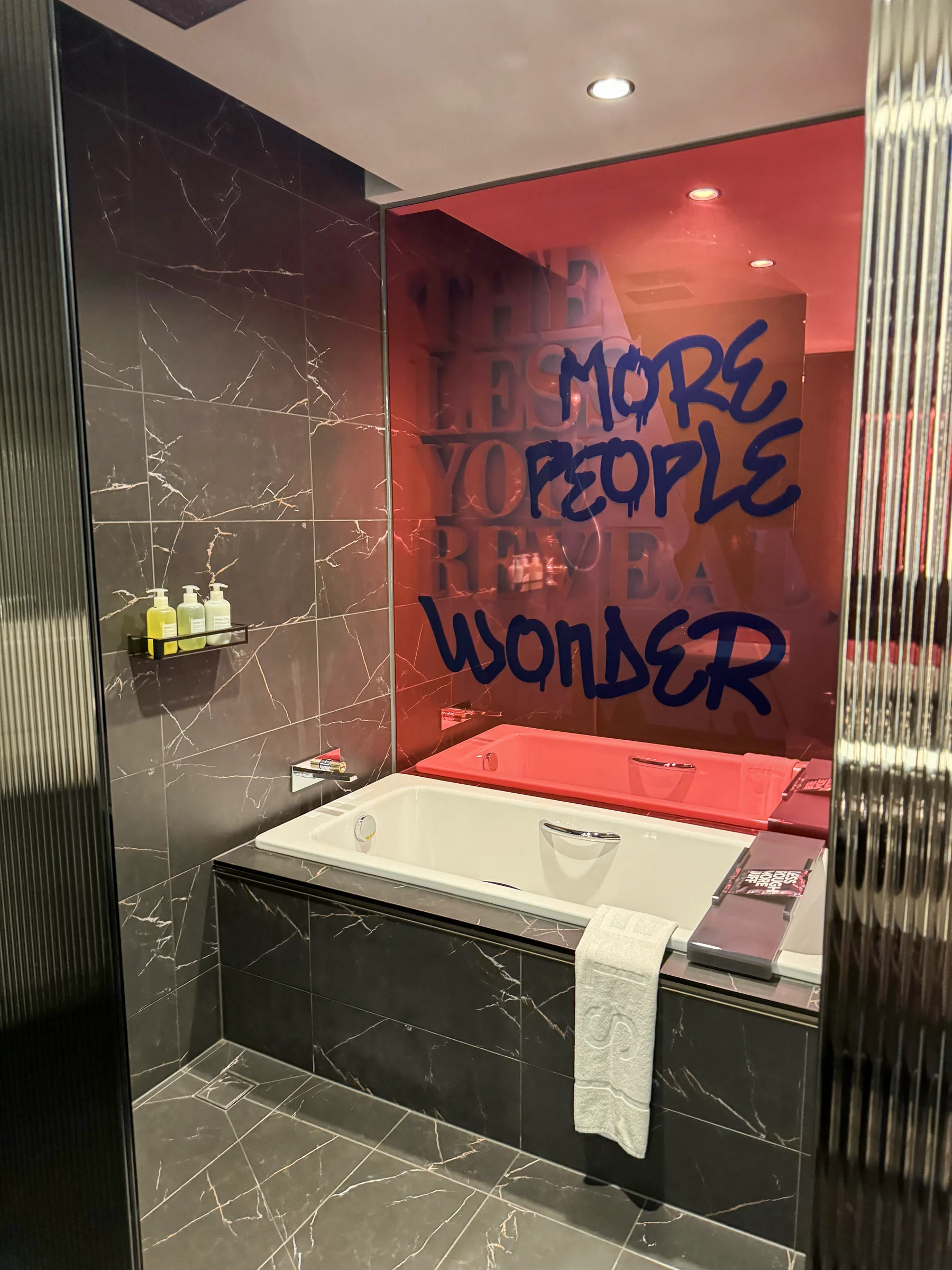 A message on the red wall and the room’s bathtub.