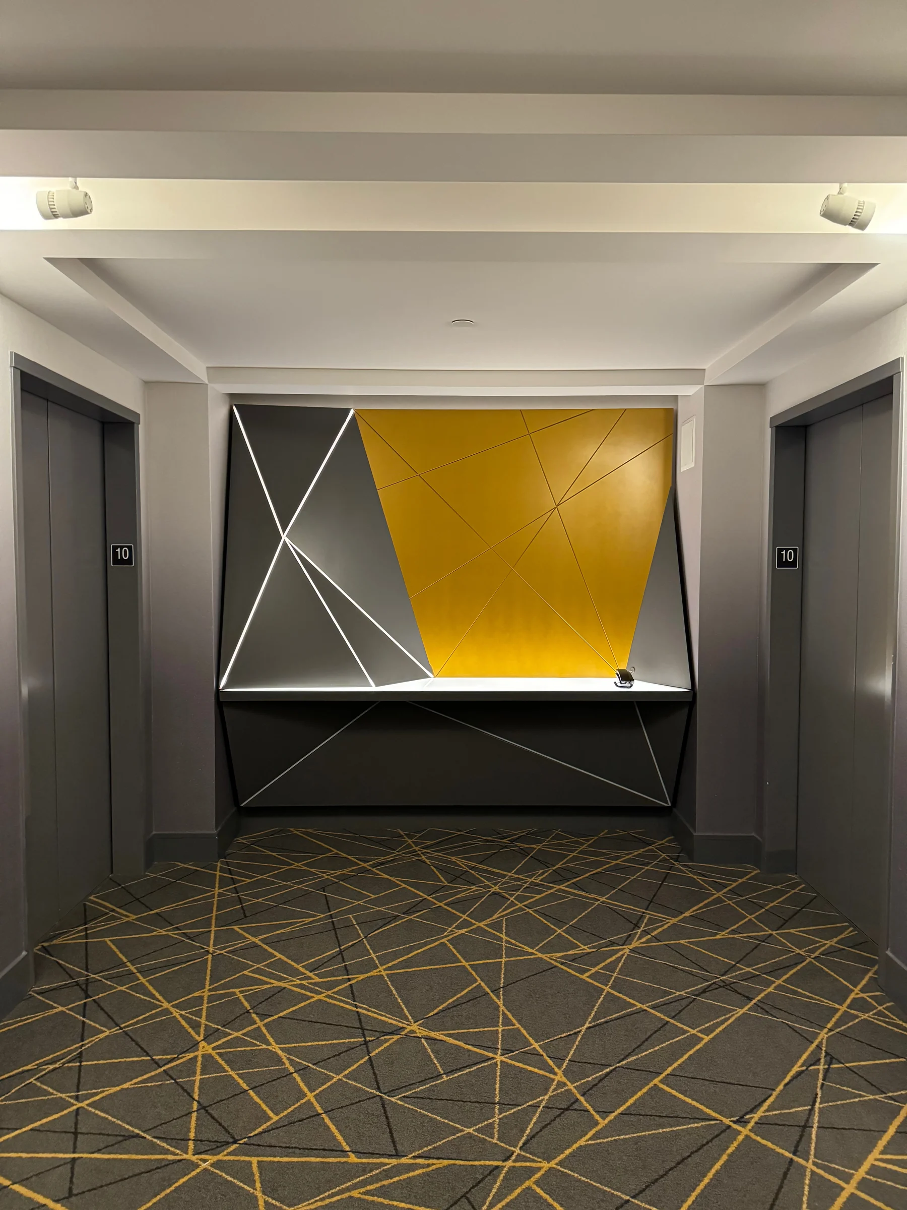 Yellow art and linear patterns along the corridor.