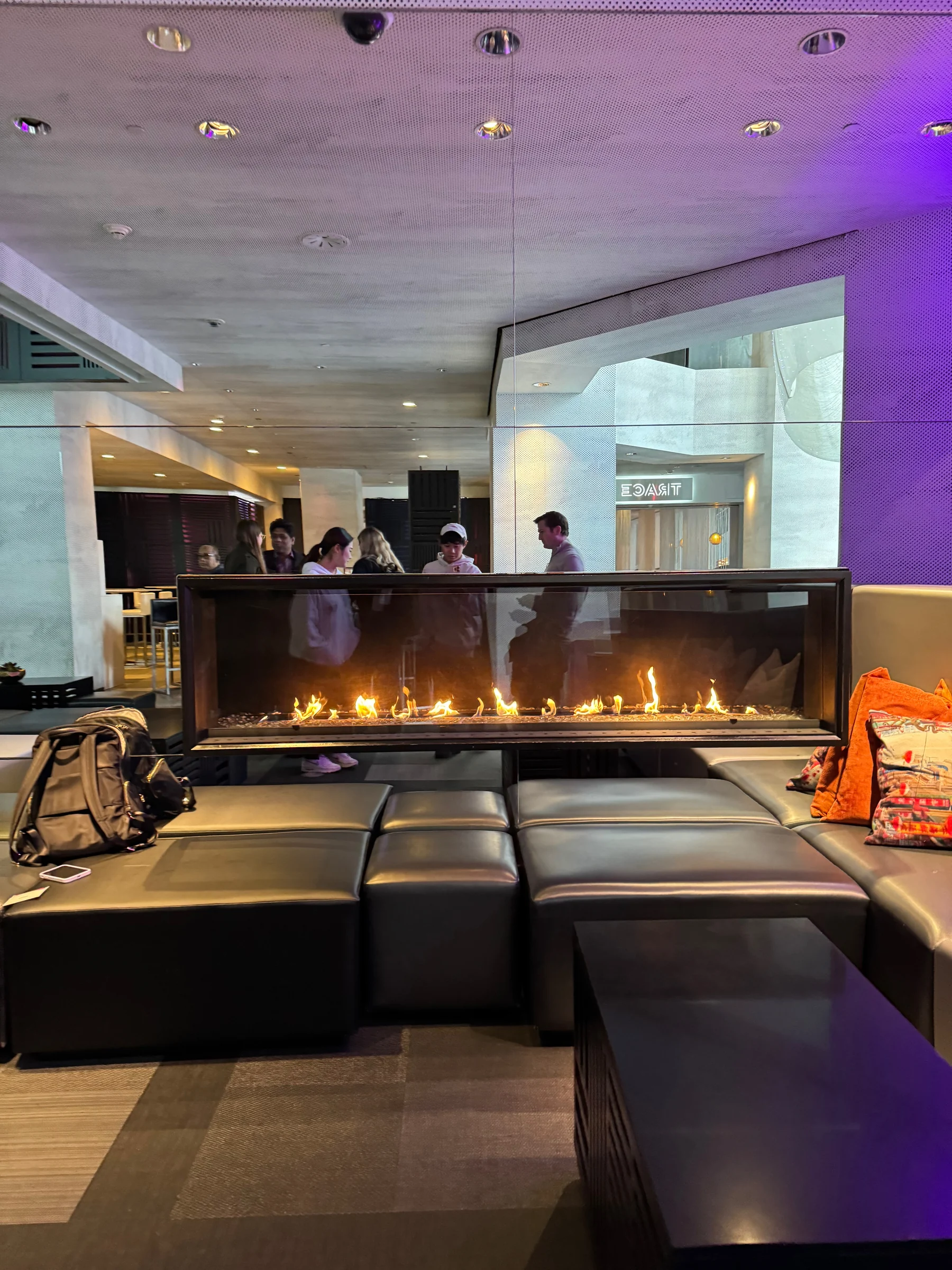 A lobby area with a fireplace and sofas.