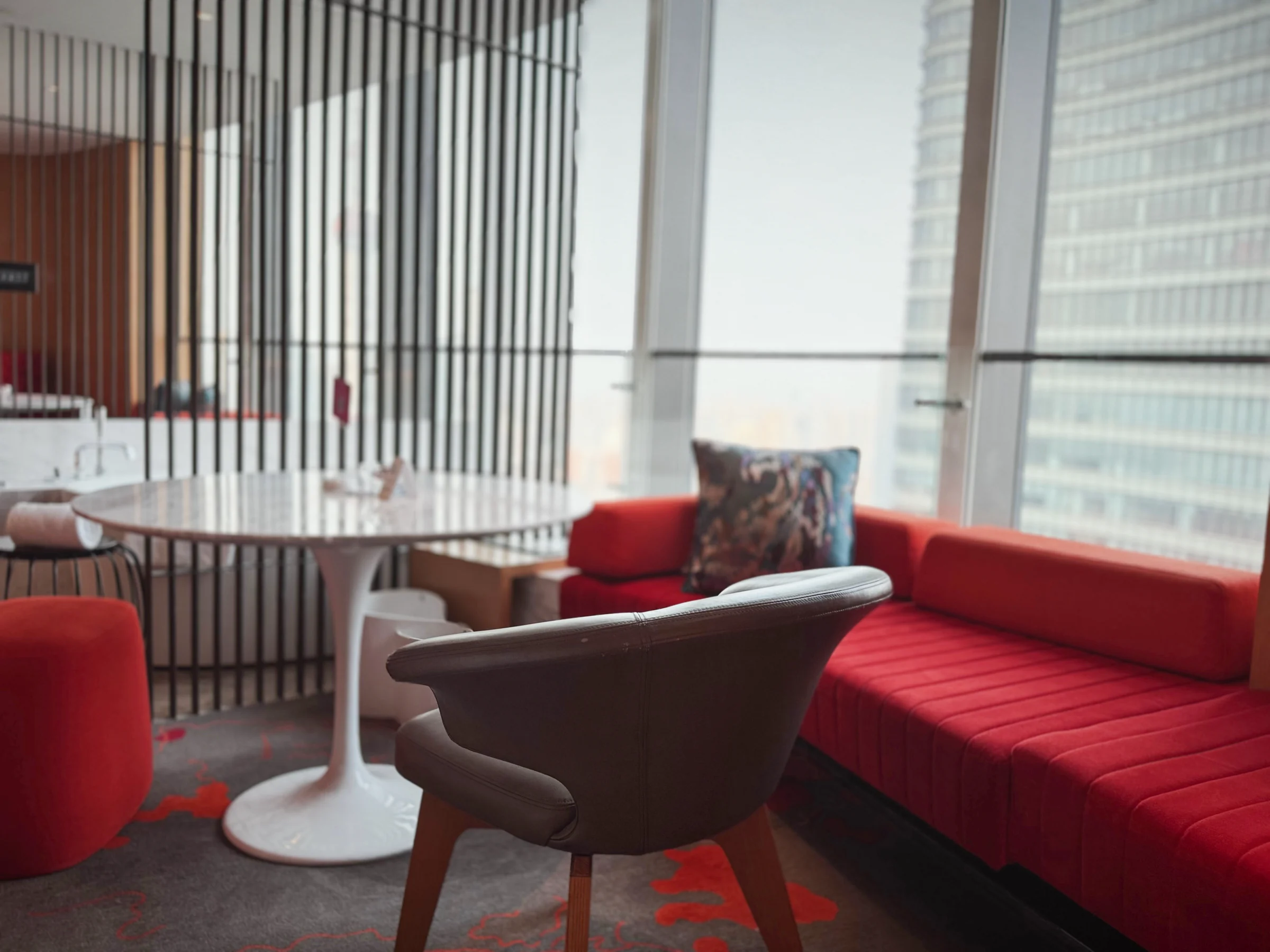 A sofa and round table by the window.