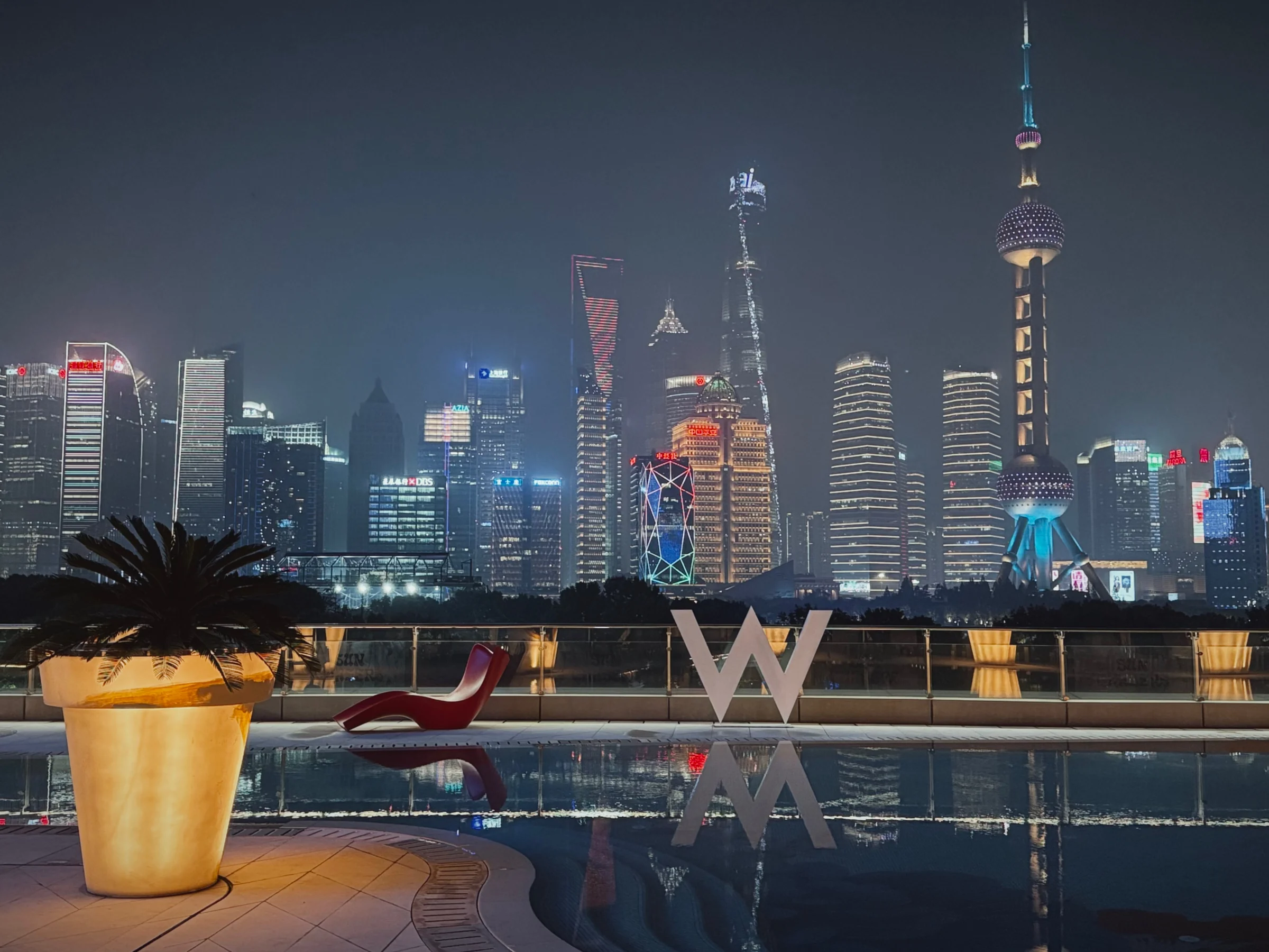 Shanghai at night across the terrace pool.