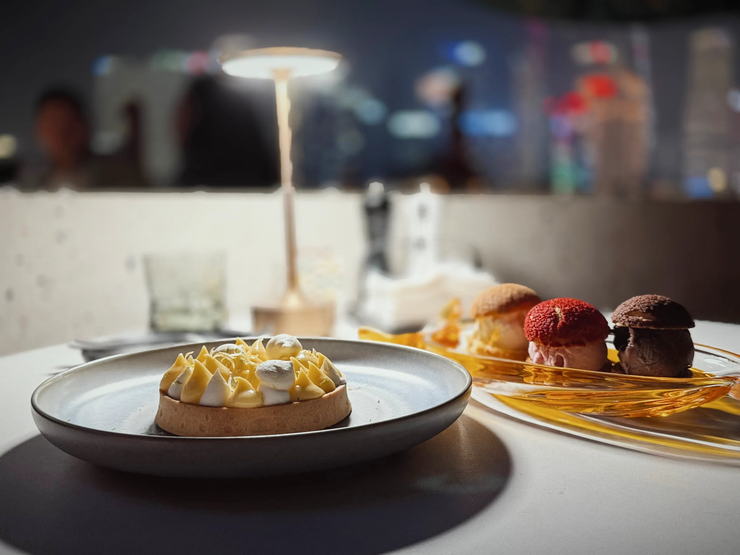 A lemon tart and ice cream with the night view.