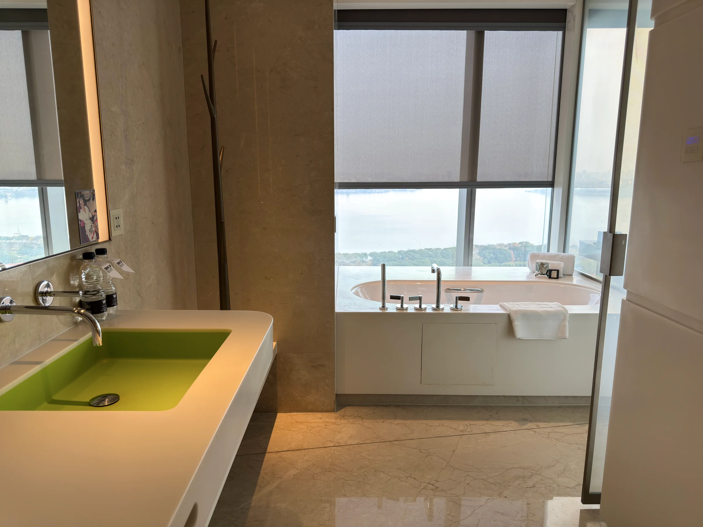 The lime-green vanity and window-side bathtub.
