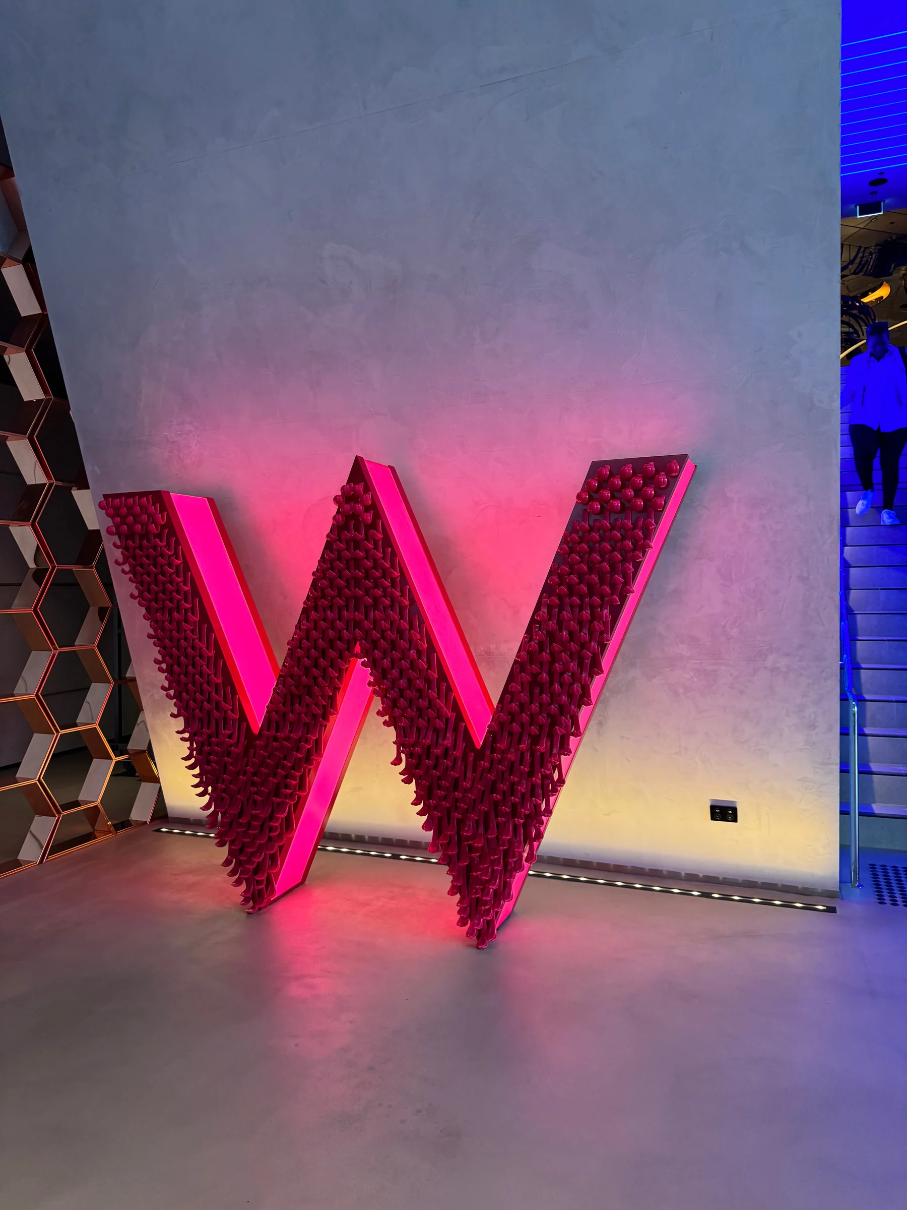 The W sign in pink light.