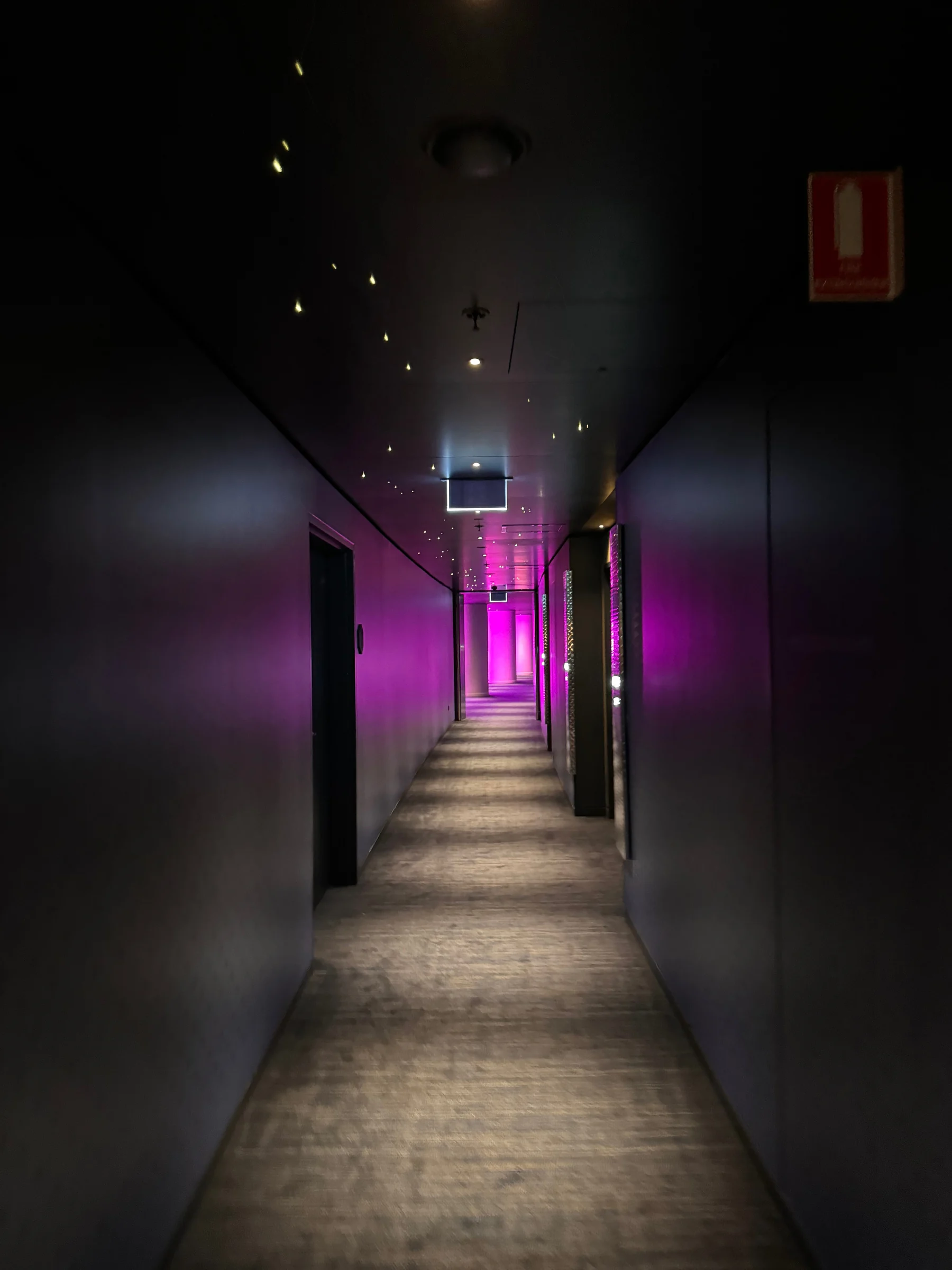 Purple light beyond a dark corridor.